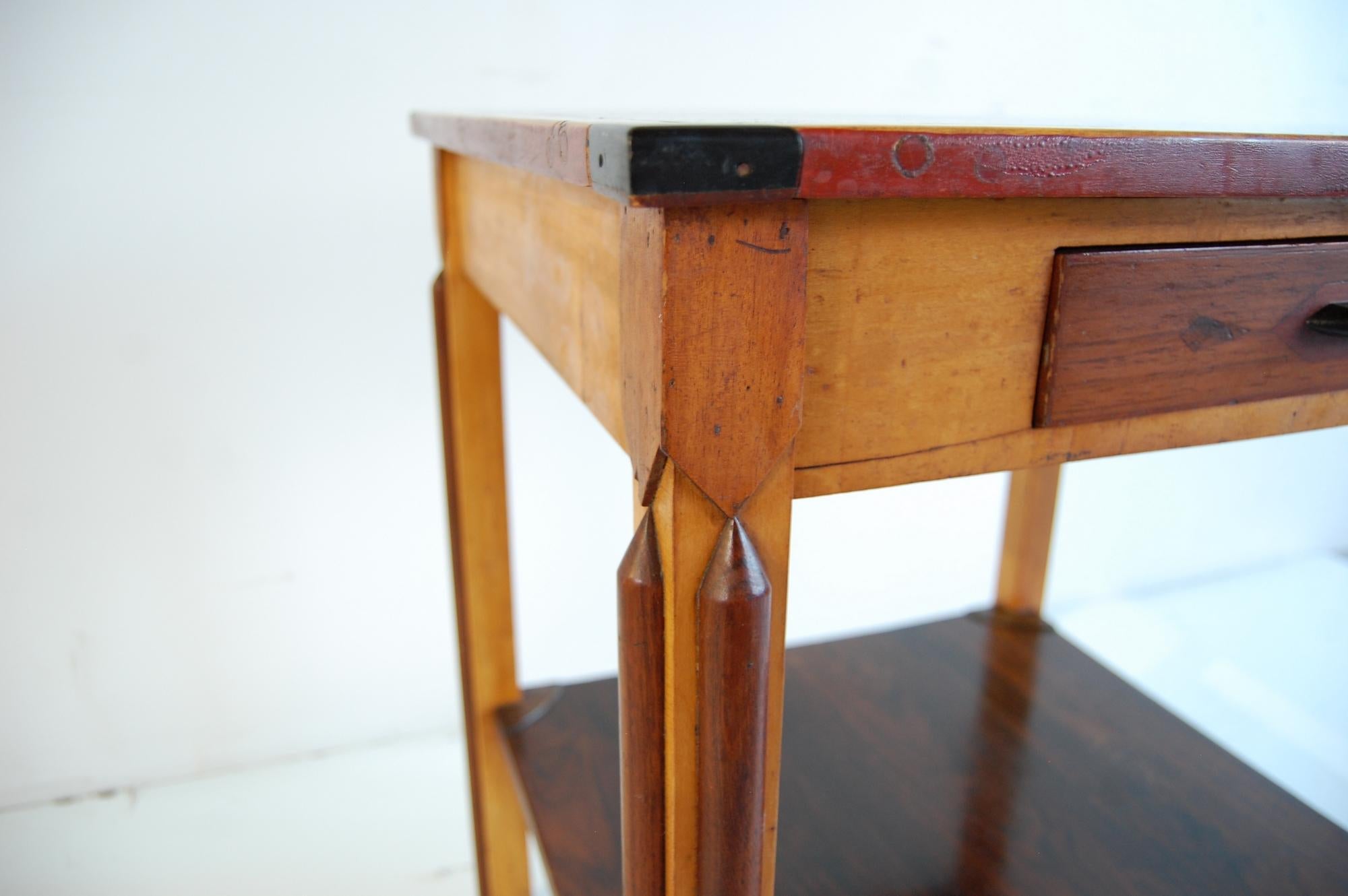 Exceptional Folk Art table, circa 1930. Table has a solid walnut top, with a solid maple border that's painted red on the edge, rosewood inlay in each corner, and solid ebony corner blocks. The bottom shelf is solid rosewood, with decorative maple