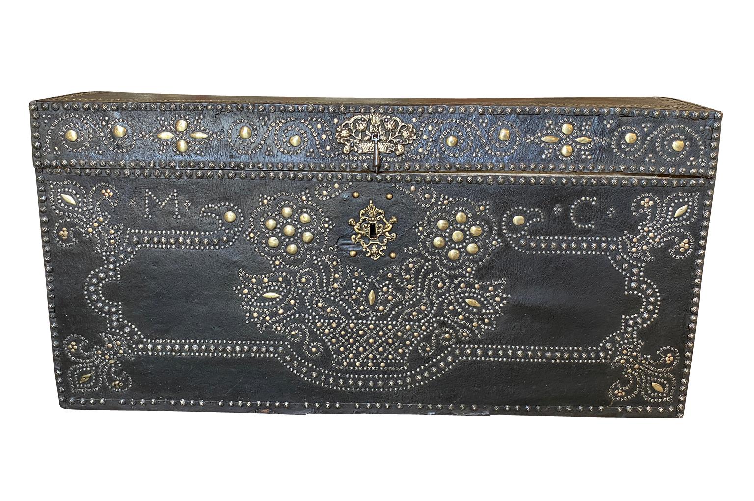 An exceptional 17th century Marriage Trunk - Malle - from the Provence region of France. Soundly constructed from wood and clad in leather. Beautifully decorated with bronze nail heads in the form of petite flowers forming a bouquet of flowers,