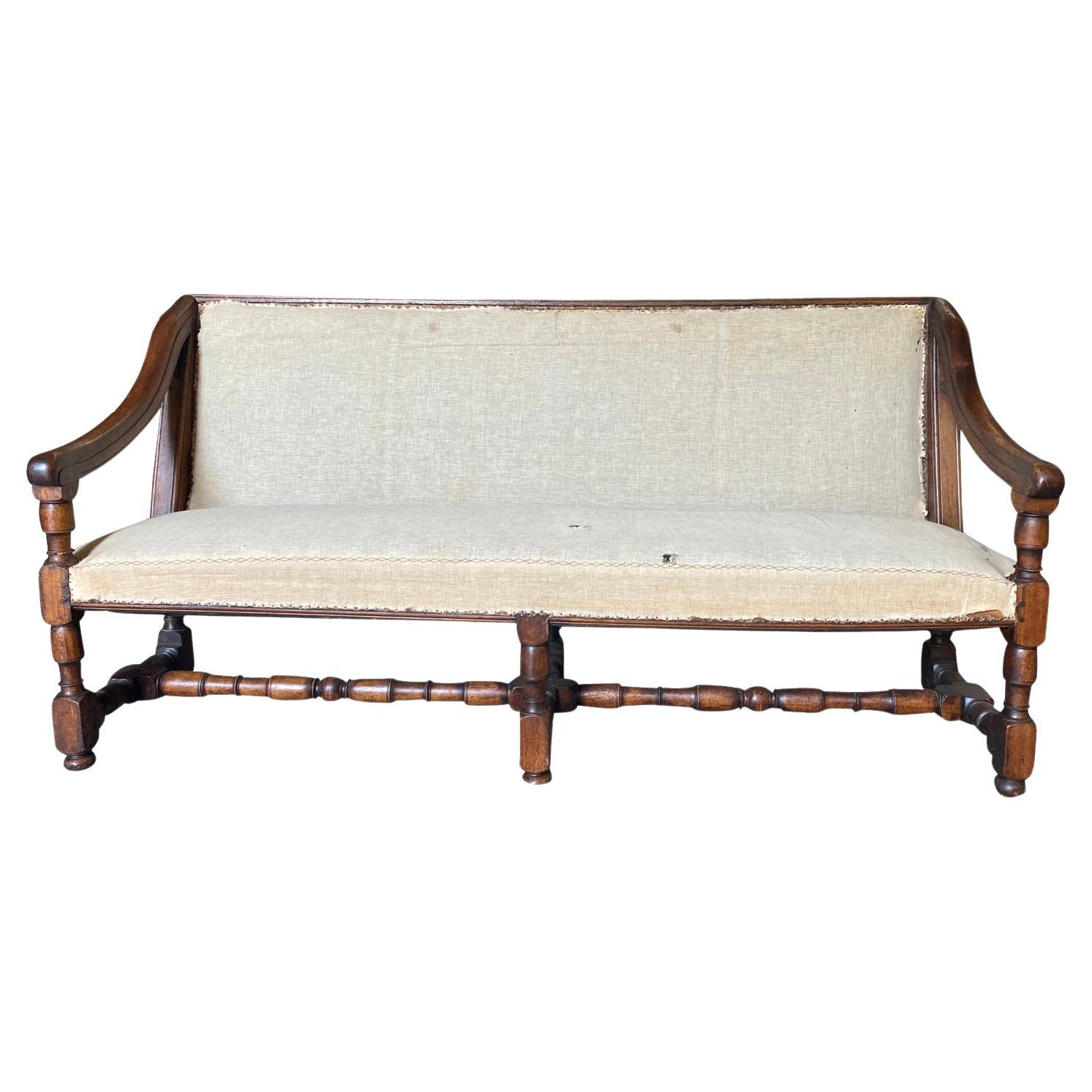 An exceptional mid-18th century Louis XIII style Sofa from the Provence region of France.  Beautifully constructed with handsome walnut and original horse hair stuffing.  This wonderful piece has hinges and butterfly bolts at the back.  Once the