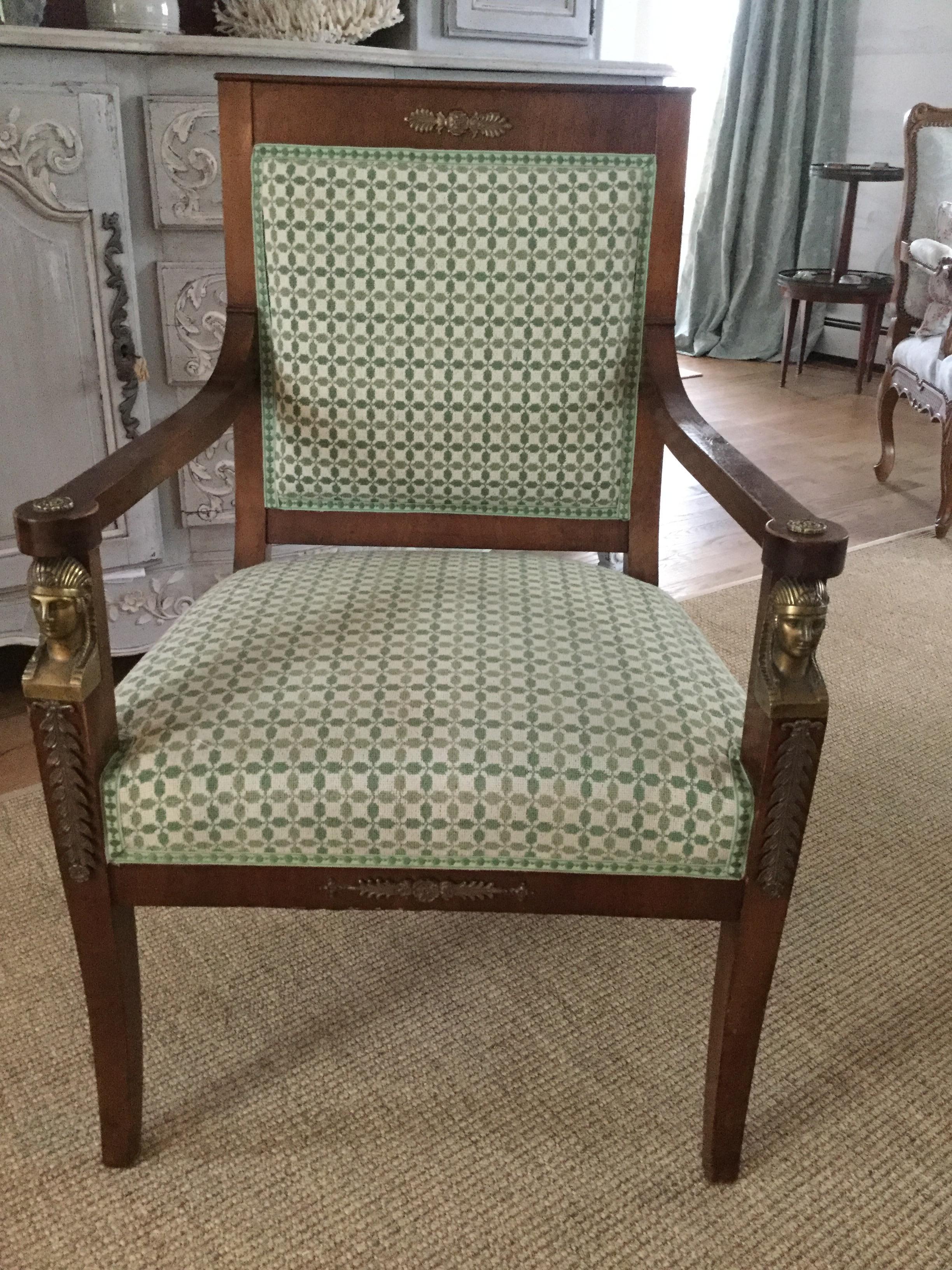 Exceptional French 19th century Empire chair featuring handsome straight lines and decorative brass Sphinx and other ormolu details. Beautifully and recently upholstered in a 2-tone green heavy cotton designer fabric and garnished with a perfect