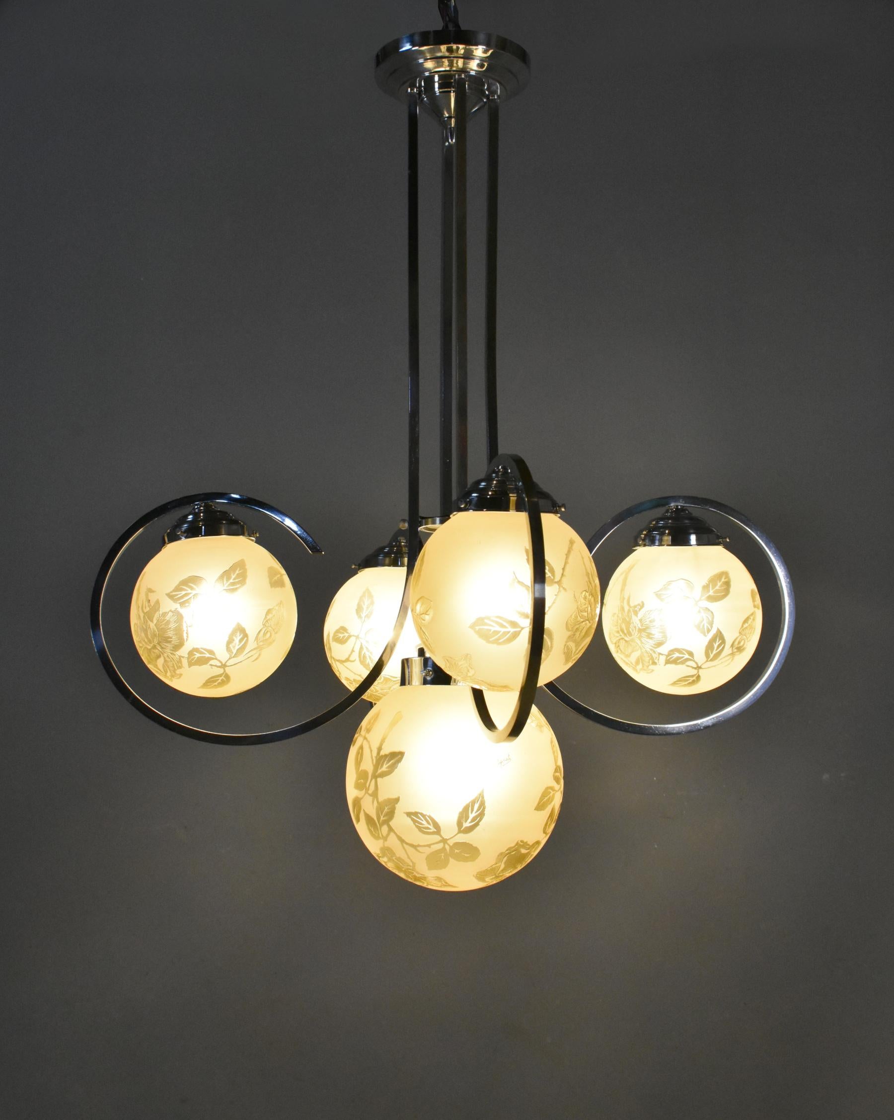 Exceptional French Art Deco chandelier light with five globes by Sprat 

A splendid chromium-plated chandelier / ceiling light features five frosted yellow globe glass light shades, each decorated with rose cuttings and signed by Sprat. 

The