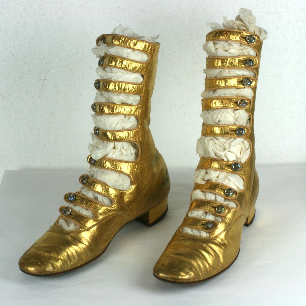 Exceptional and rare French Art Deco Gold Kid Boots. Of fine gold kid leather with high multi strapped instep closed with Tiffany style art glass iridescent shoe buttons. Sole stamped 