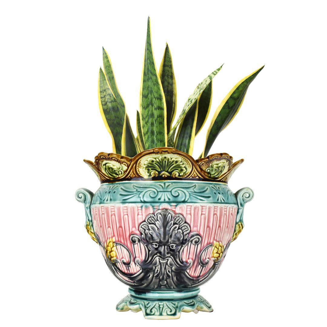 This cachepot is crafted from high-quality ceramic, typically Majolica or Barbotine, known for its vibrant, glossy glaze. The glaze gives the piece a lustrous sheen and adds depth and richness to its pastell colors.

The defining feature of this