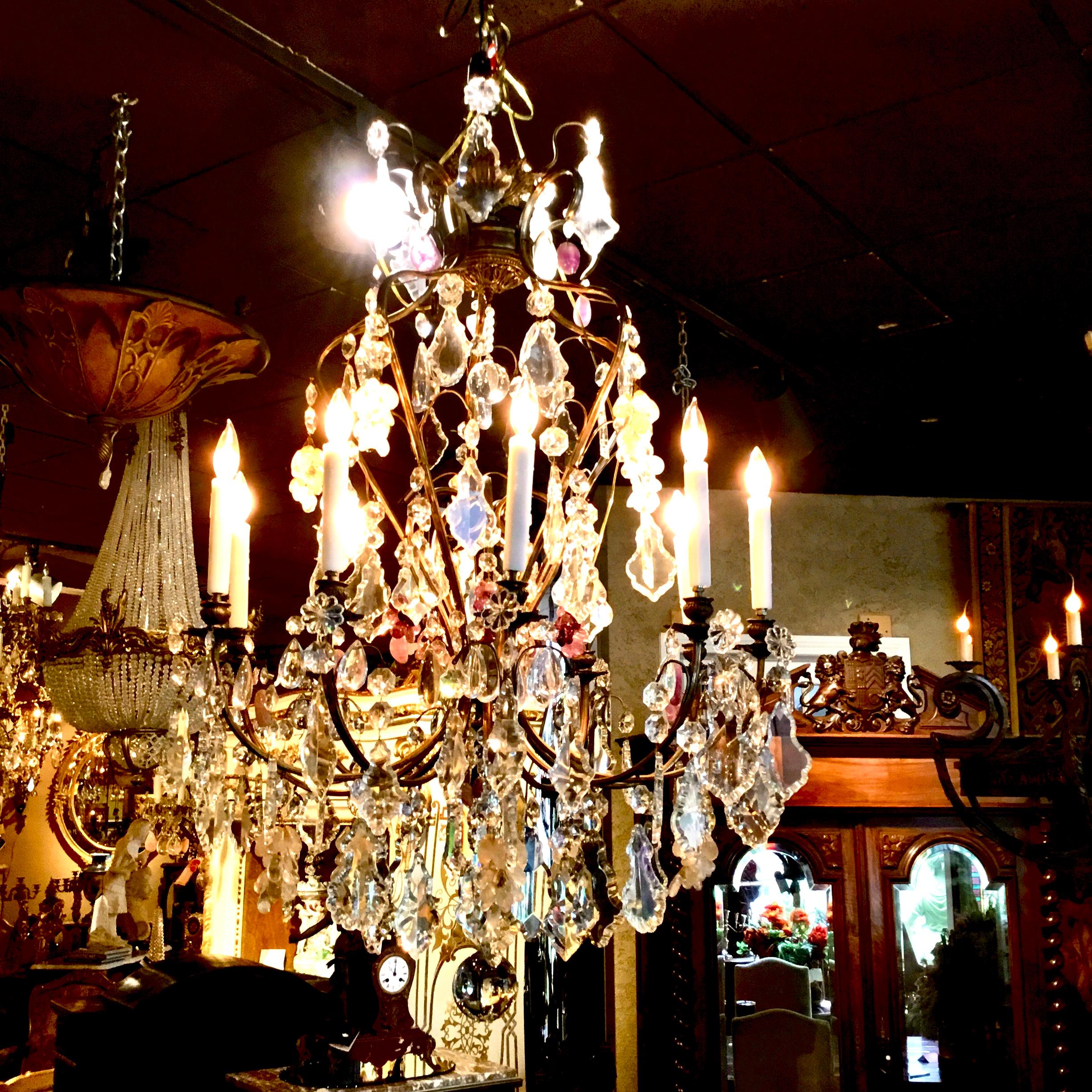 Large and exceptional bronze dore chandelier with scrolling arms and ending in a finial.
The crystals are very large clear, rock and Smokey rock crystal, having eighteen lights.
Gilt bronze post that is special by having an urn and other swirling