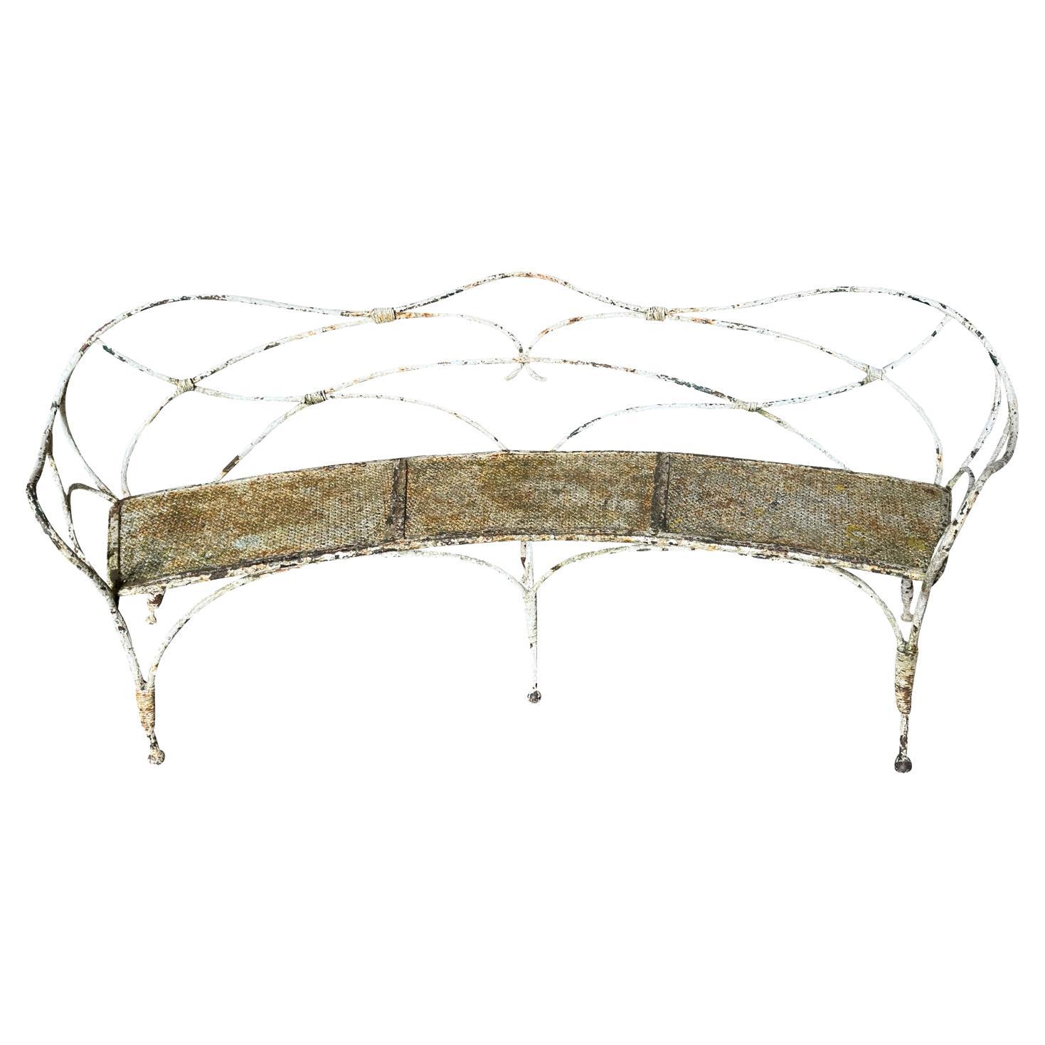 An exceptional Iron Garden Bench from the Provence region of France.  Magnificently crafted in iron in the taste of renowned French interior designer Jean Michel Frank (1895 - 1941).  Stunning detail and patina.   