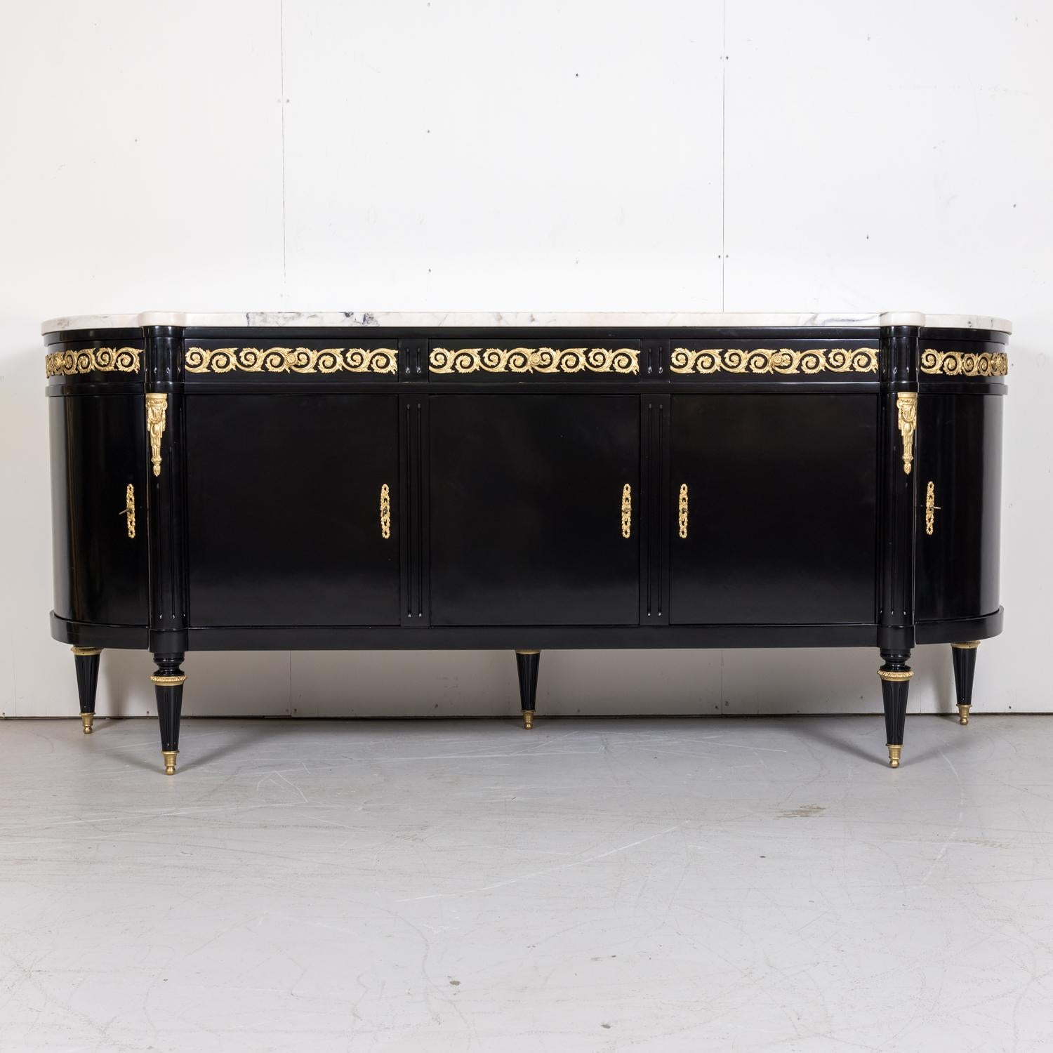 An exceptional and stunning mid-20th century French Louis XVI style five drawer, five door demilune enfilade buffet attributed to the famed Maison Mercier Freres of Paris, circa 1940s. Having a lustrous newly ebonized semi-gloss lacquered finish,