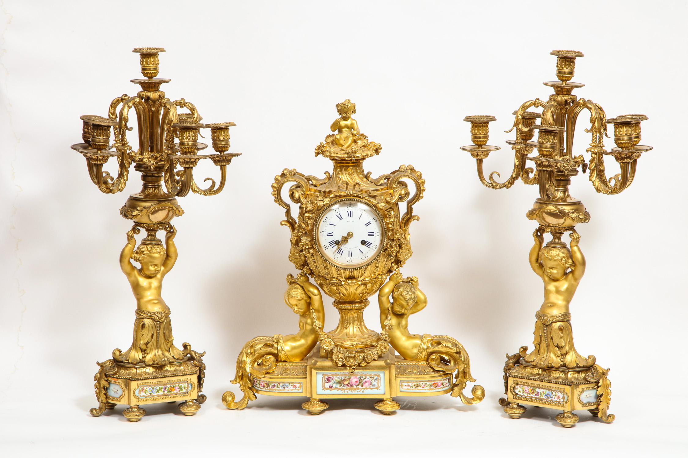 An exceptional quality French bronze / ormolu-mounted teal green porcelain three-piece clock garniture set, circa 1880

By Lepine, Paris.

Dial and movement both signed Lepine.

Comprising of a clock and a pair of matching candelabra.
 
The