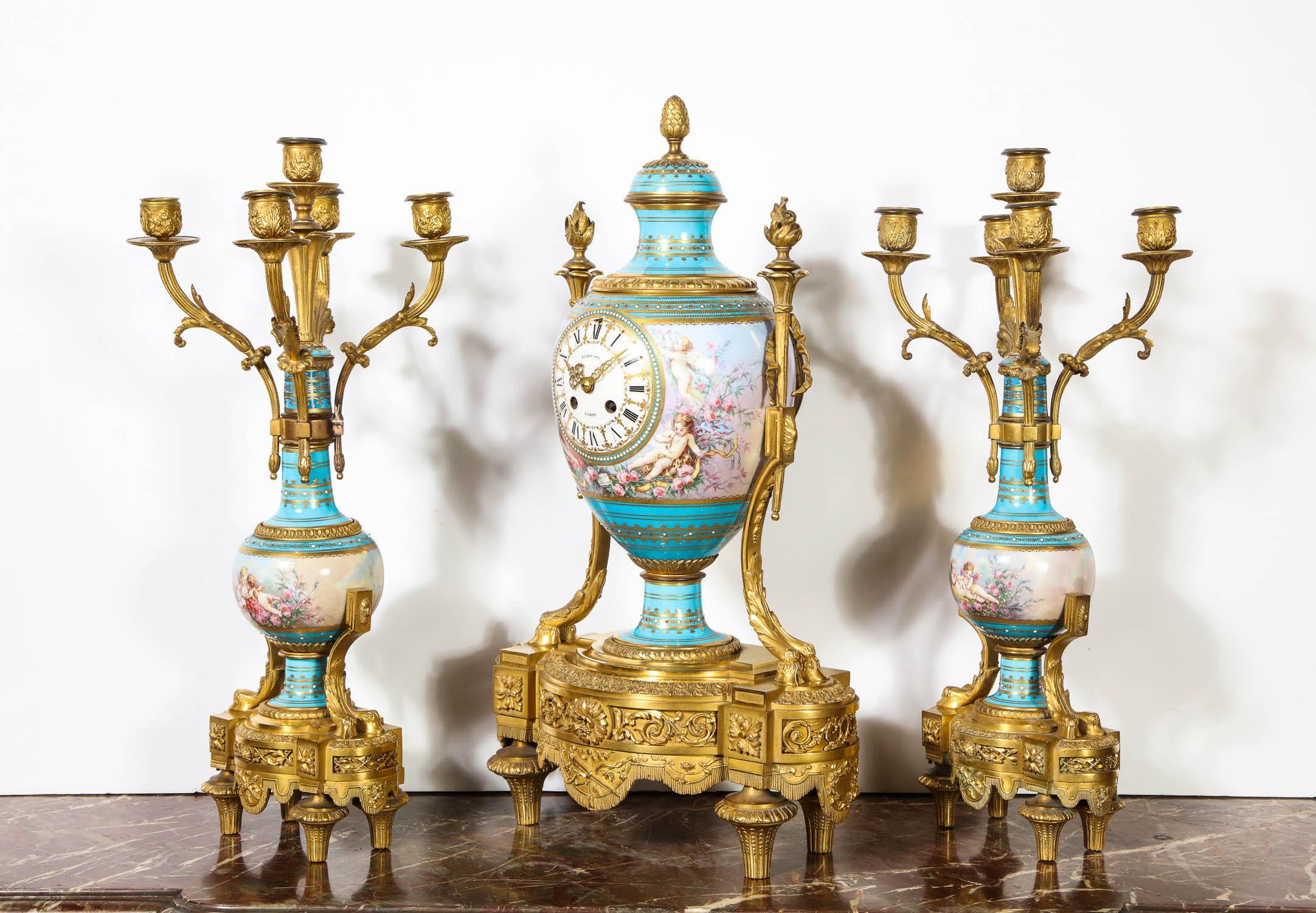 An exceptional French bronze ormolu mounted turquoise jeweled Sèvres Porcelain clock set by Raingo Fres Paris, circa 1880.

Comprising of a clock in vase form and a pair of five-light candelabra. The ormolu is of very high quality and the