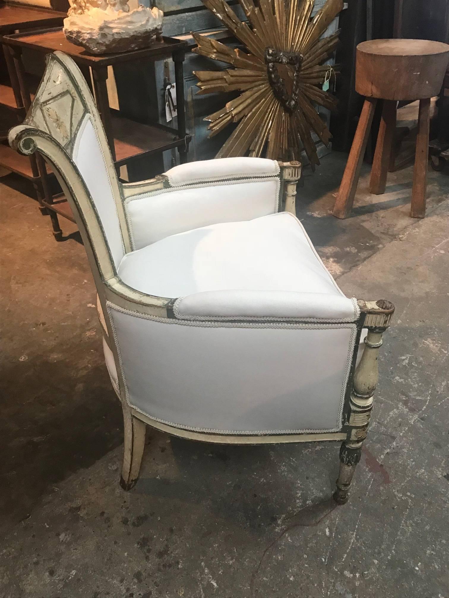 An exceptional French period armchair - Bergere chair. Wonderfully and sturdily constructed with its original polychromed finish. Professionally reupholstered recently. A perfect accent piece for any interior.