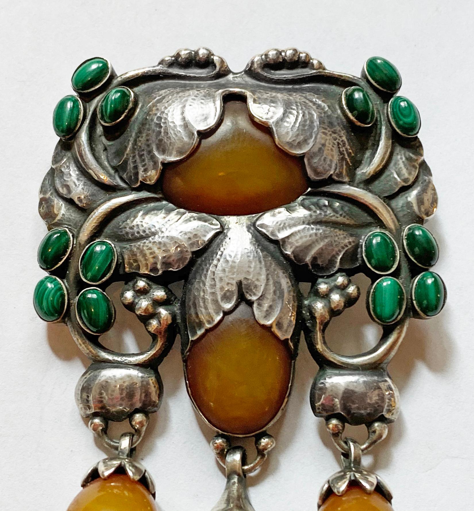 Exceptional  Georg Jensen large rare design Silver and Amber and Malachite Master Brooch, C.1933. Georg Jensen. Designed as foliate and bud motifs set with and suspending amber cabochons and drops, with malachite cabochons, no. 96, 10.0 x 6.2 cm,