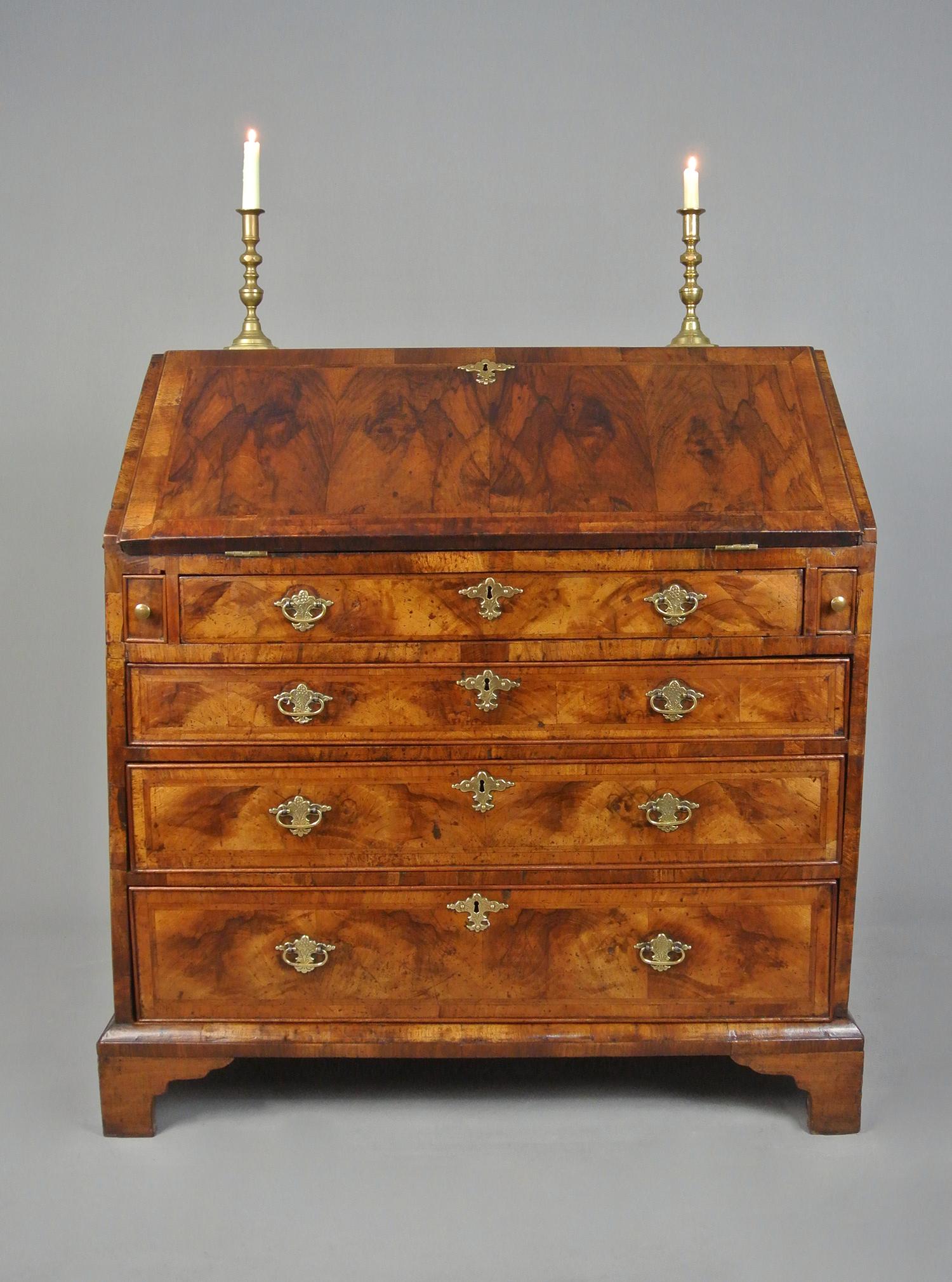 With a fantastic colour, and in rarely seen Yew wood, this beautiful bureau dates from the reign of George II c. 1750.

With oak lined drawers and a handsome interior of small walnut drawers and pigeon holes and a door with figured walnut inlaid