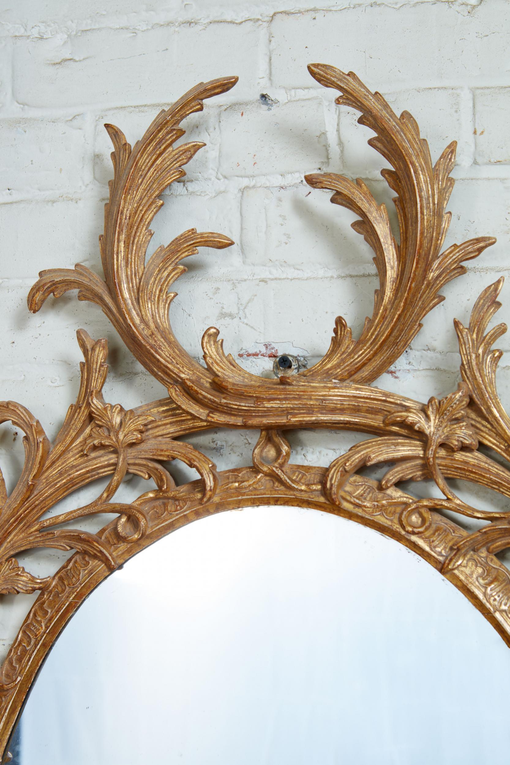 Very fine George III giltwood mirror in the manner of John Linnell, the exceptionally carved frame of typical palm frond form, in this case successfully augmented with trailing interwoven vine, the plate encircled with acanthus leaf carved inner
