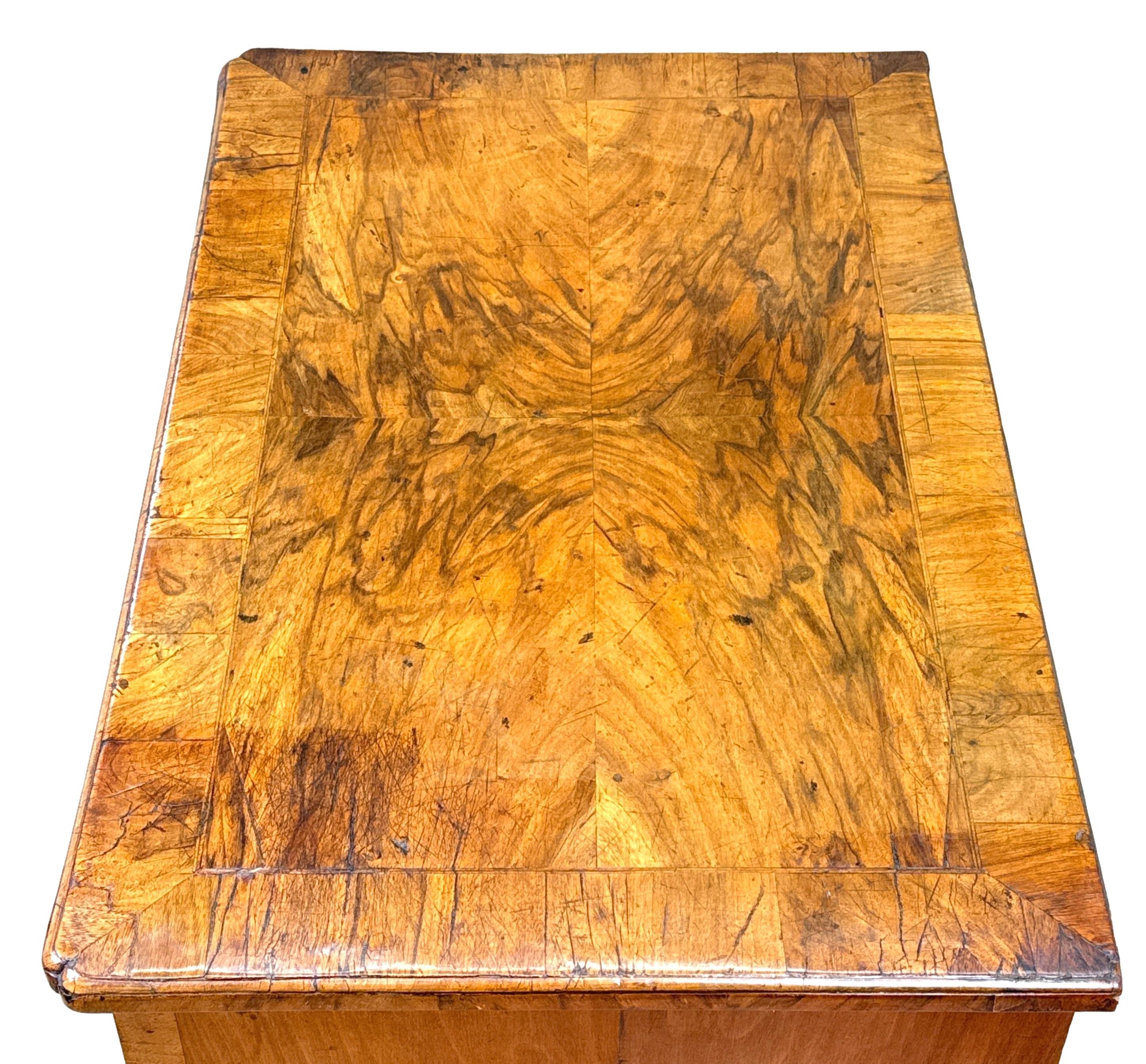 A Wonderful 18th Century George I Period Burr Walnut Kneehole Desk, The Extremely Well Figured Quarter Veneered Top Wth Crossbanded Decoration And Re-Entrant Corners, Over One Long Drawer and Six Short Drawers With Feather Banded Decoration And
