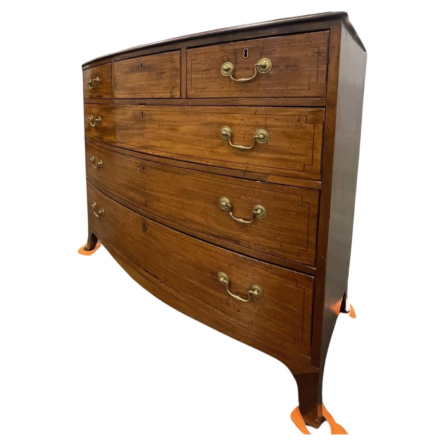 An exceptional quality Georgian Bow Front chest of drawers. With bracket feet and absolutely awesome patina and with original key. This is a unique and rare find, the drawer configuration is hard to come by Three short over three long with inlay