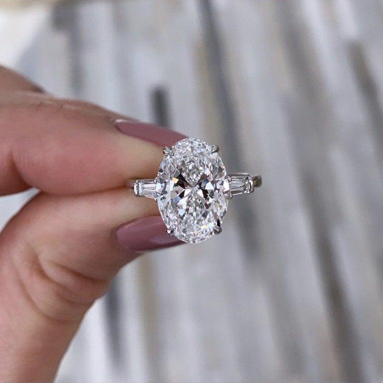 This exceptional ring features a GIA certified 4.03 carat oval diamond, elegantly set in 18K Wnite Gold with tapered baguette side stones. 

The diamond has an F color grade with minute inclusions detectable only by an expert, this diamond is graded