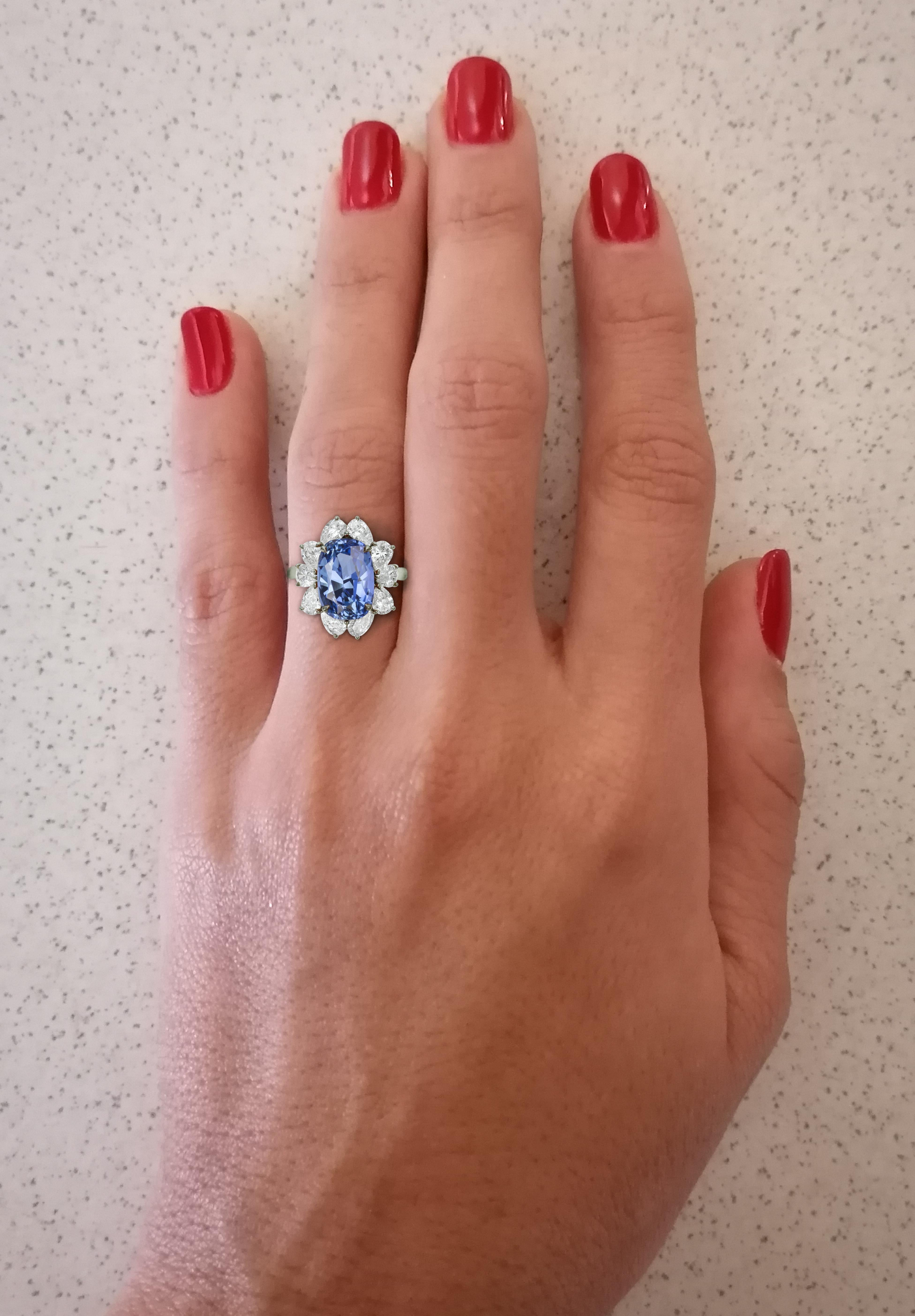 This is an exquisite ring handmade in Italy with a 5 carat GIA certified sapphire and pear cut diamonds platinum ring. This ring comes with 11 GIA certificates one from the blue sapphire and 10 from the pear cut diamonds. Every diamond has been