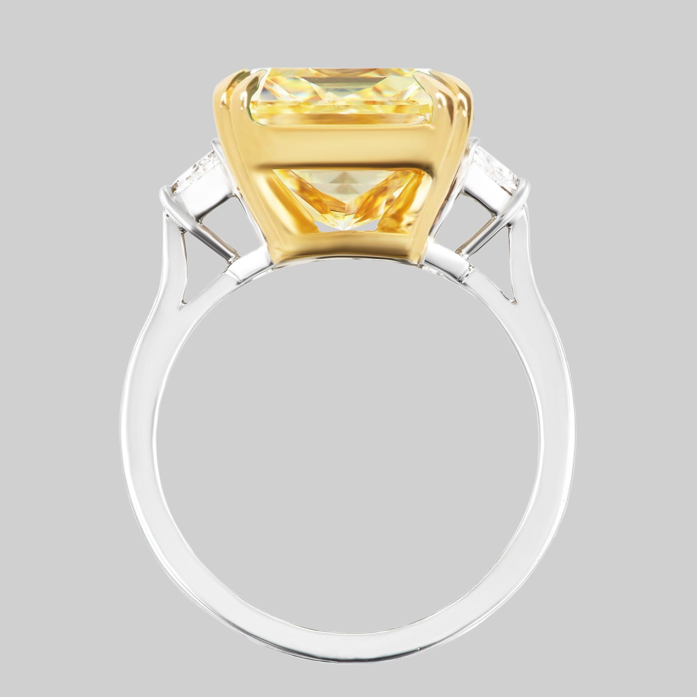 An exquisite long radiant cut diamond set in solid Platinum and 18K Yellow Gold Fancy yellow Three stone diamond ring, the center stone is Canary yellow diamond, weighing 5 Carats Fancy Yellow VVS in Clarity, Certified by GIA, Radiant Cut.
Set with