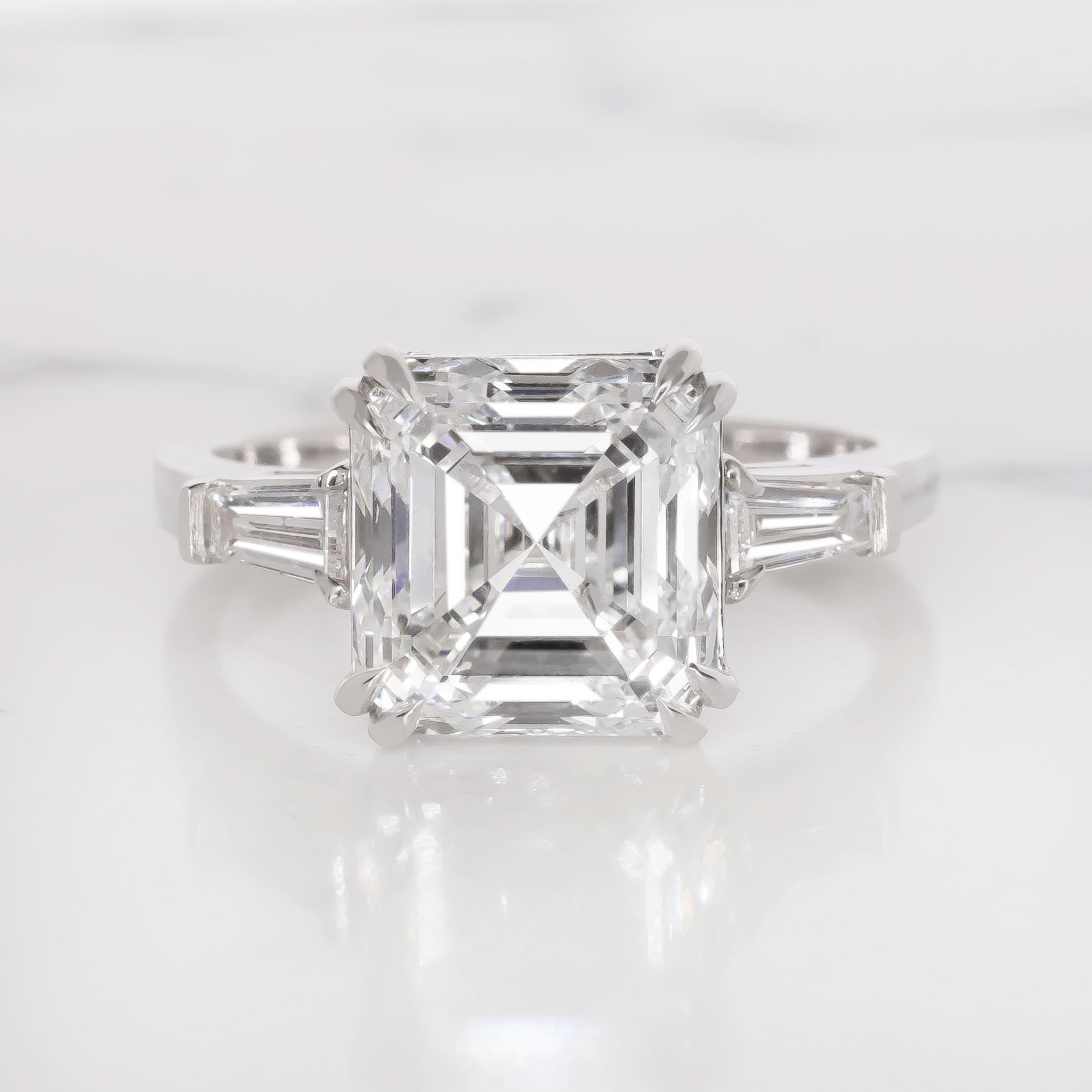 GIA Certified 5 Carat Asscher Cut Diamond Platinum Ring 
I Color
VS2 Clarity
Excellent Polish
Veri Good Symmetry 
None Fluorescence
Diamond from Botswana!
Tapered baguettes diamonds side stones.

Setting made in solid platinum

