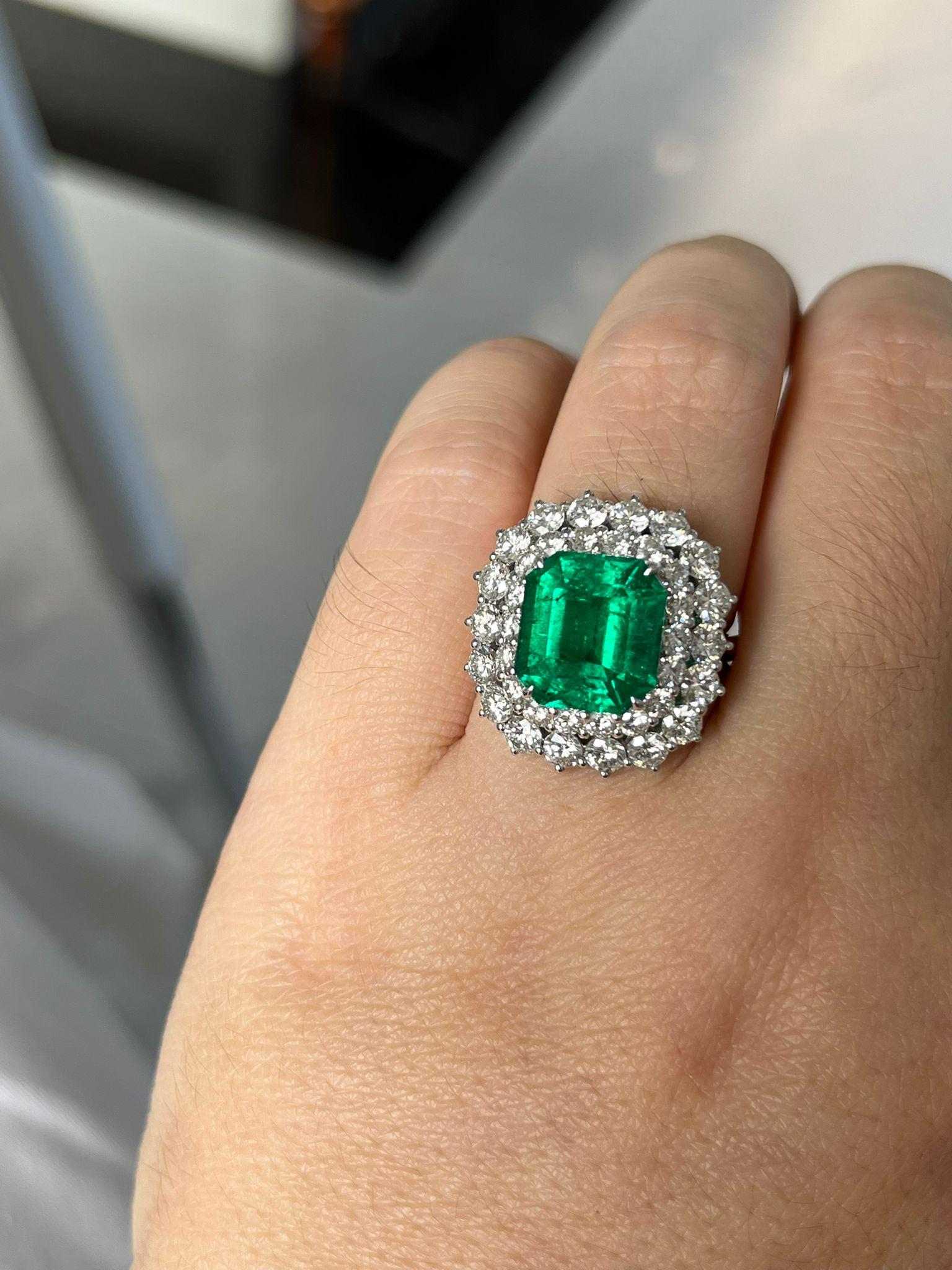 An exquisite Colombian Emerald Cut Natural Green Emerald Diamond Pave Ring. 
minor oil
18 carats white gold
