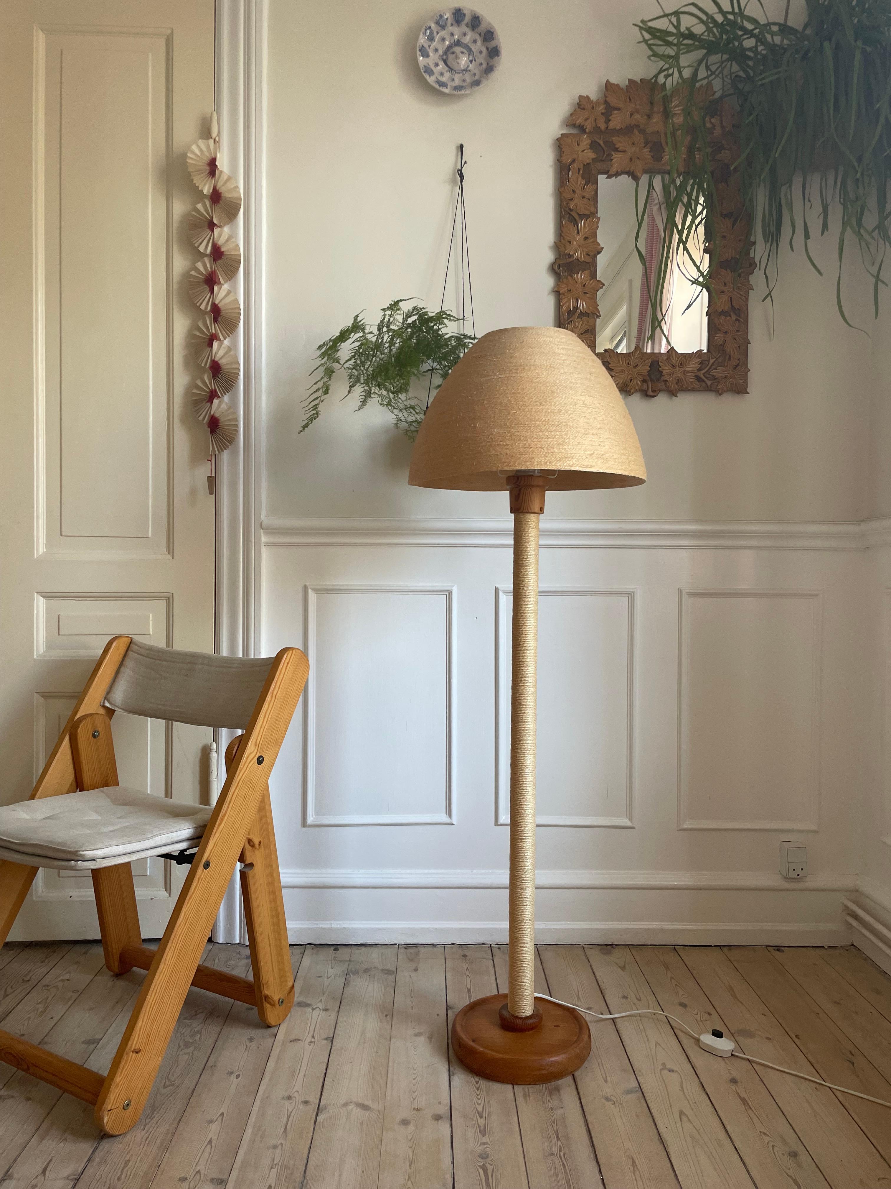Very rare Hans-Agne Jakobsson (1919-2009) floor lamp from the 1960s. Wooden stem covered with neatly layered thin rope from base to top. Original lamp shade of matching layered thin rope molded in a soft shape fitting perfectly over the shade