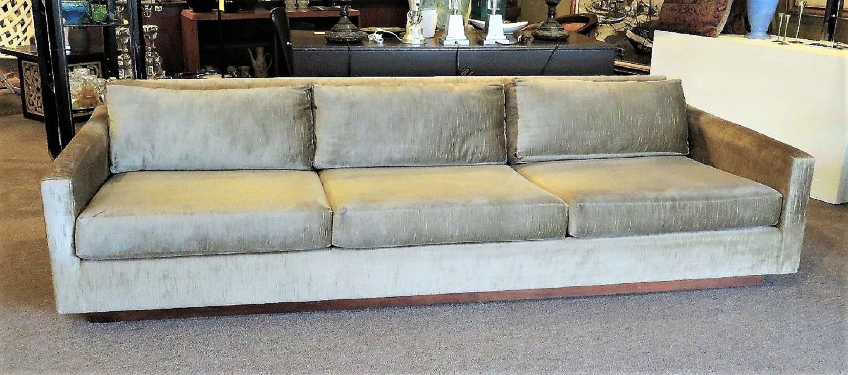 Exceptional Tuxedo sofa in a cut silk velvet attributed to Harvey Probber. A three-seater, it is raised on a walnut plinth base with feather back pillows. Unusual for a Tuxedo Style sofa in that it has a back support. Reupholstered in the 1980s, it