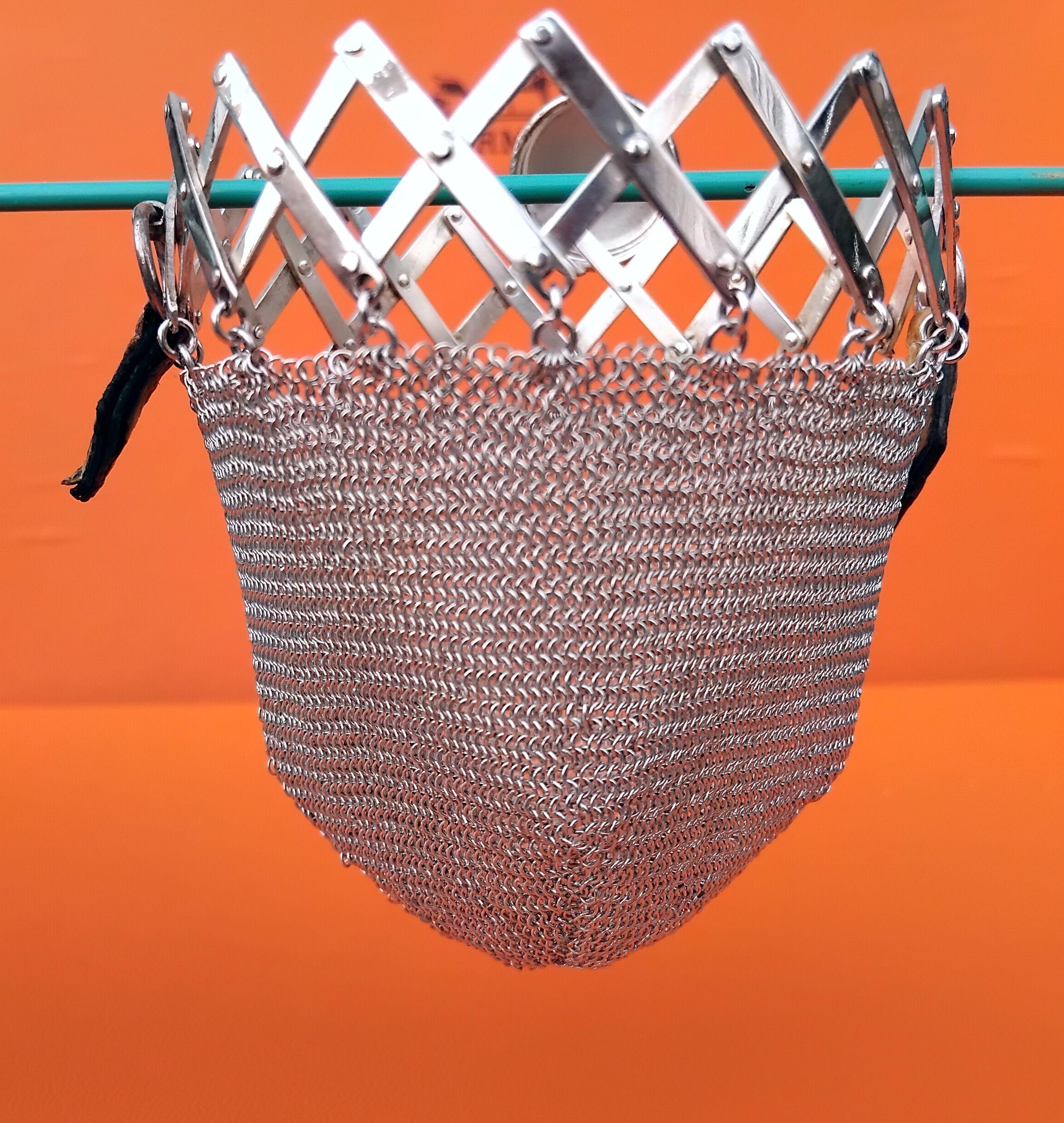 Extremely Rare Authentic Hermès Chainmail Coin Purse 

The purse is a vintage item, made of flowing mesh, enhanced with a retractable opening that closes with a lid

2 rings holding 2 pieces of leather

Made of silver 835 (engraved on of of the