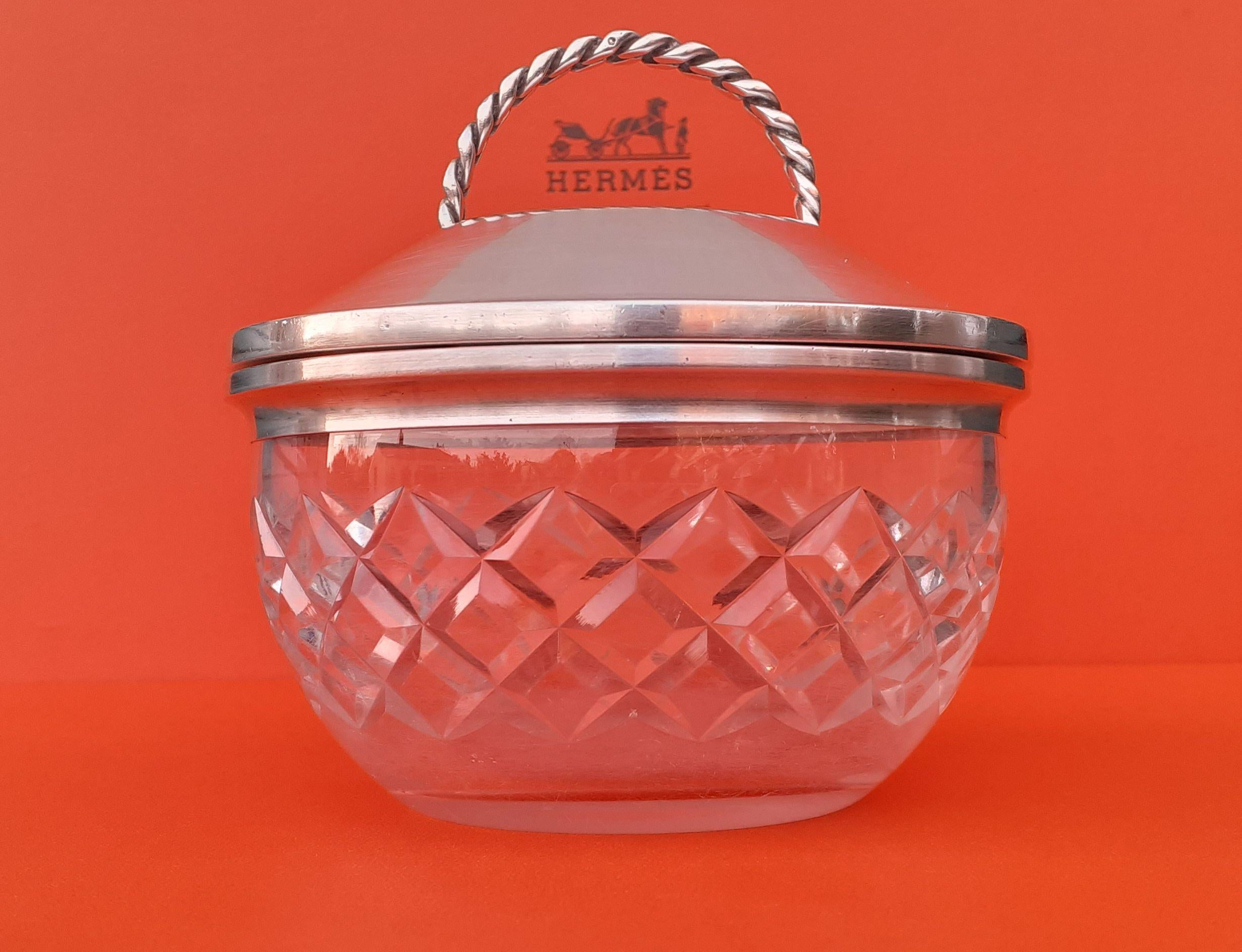 Exceptional Authentic Hermès Dish

Can be used to store your sweets, cakes, jewelry etc ...

Made in France

Vintage item

Made of Glass and Silver

The glass jar is made of thick and resistant glass, decorated with squares cut in the mass

The