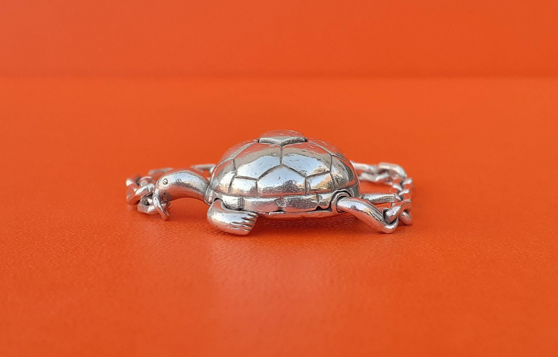 Rare Authentic Hermès Charm or Key Ring

Turtle Shaped

Can be used as Bag Charm or Key Ring

Made of Silver

Vintage Item

Colorway: Silver-tone

Secret mechanism: you have to press on the back of the turtle and pull on its left hind paw at the