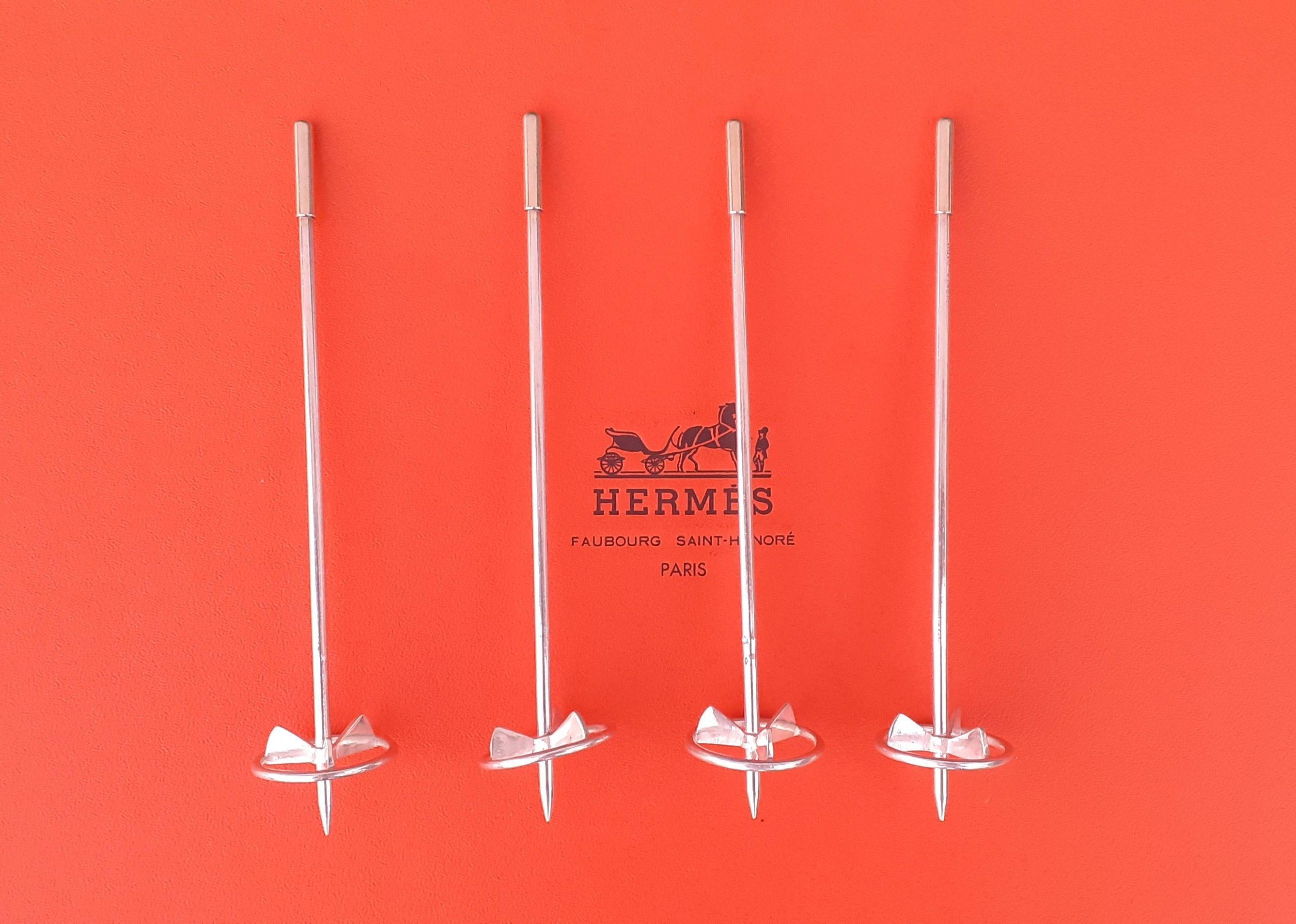 Stunning Authentic Hermès Cocktail Stirrers

Can be used as Champagne whip or swizzle-stick  to remove the bubbles from fizzy drinks

In shape of Ski Poles

The set includes 4 pieces

Vintage Item

The sticks are in silver and the ends in silver