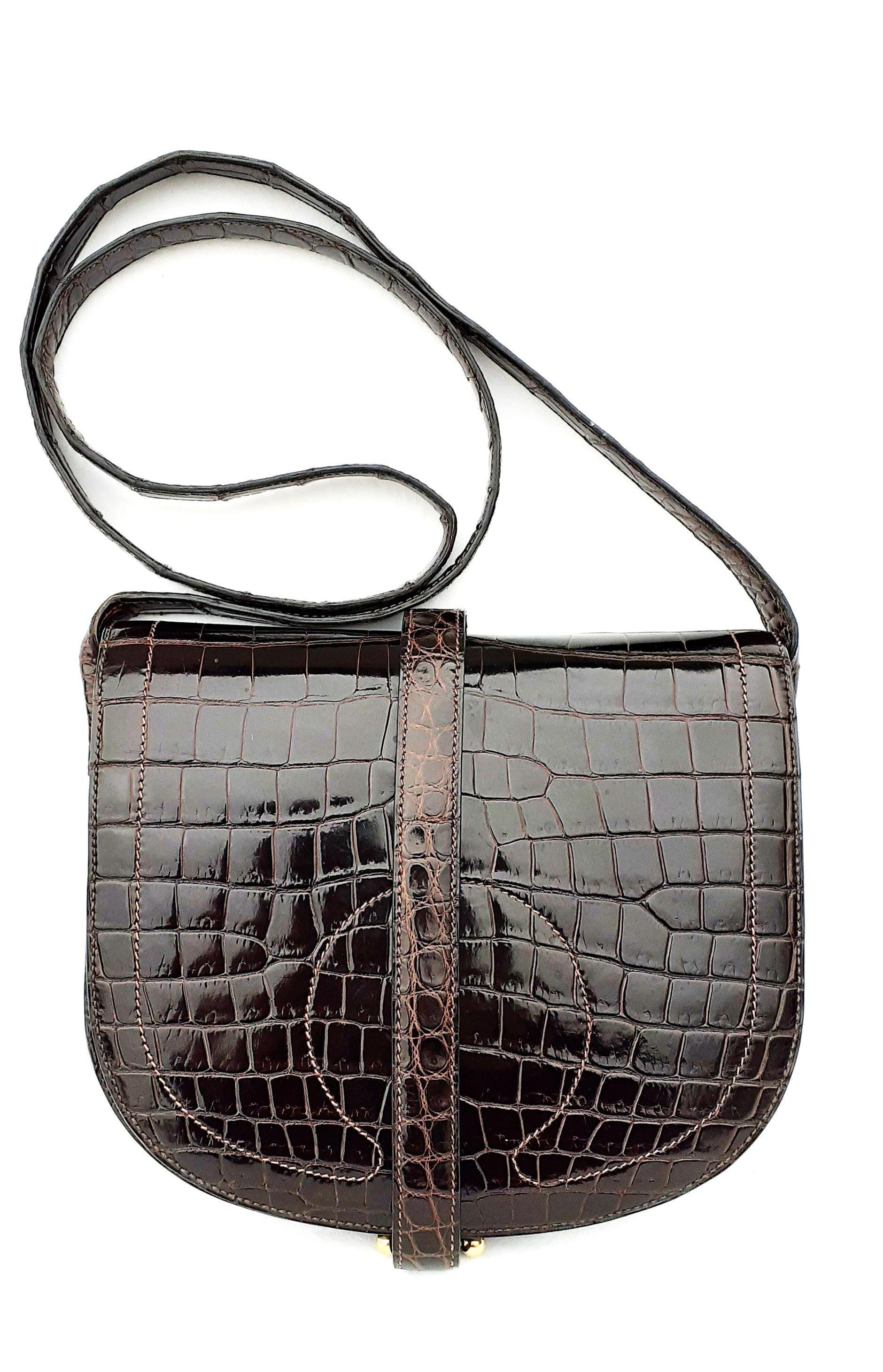 Gorgeous Authentic Hermès Bag

Can be carried Shoulder and Crossbody

Made in France

Vintage (seems to be a stamp L in a circle)

Made of Crocodile Porosus and Golden Hardware

Lined with smooth lambsin Leather

Colorway: Shiny Dark Brown, Gold
