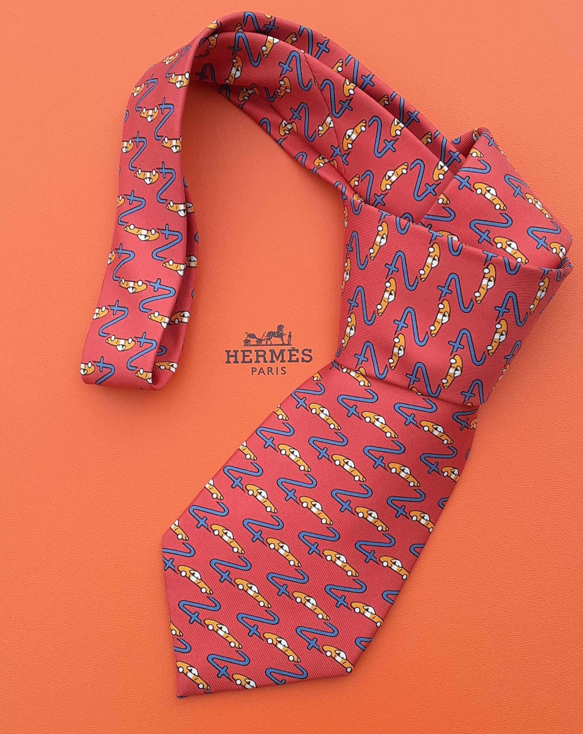 Rare and Lovely Authentic Hermès Tie

Made especially by HERMÈS for the 24 HEURES DU MANS race

Print: Racing cars and a road drawing the number 24

Made in France

Made of 100% Silk

Colorways: Red, Blue, Orange, White

Lined with plain red