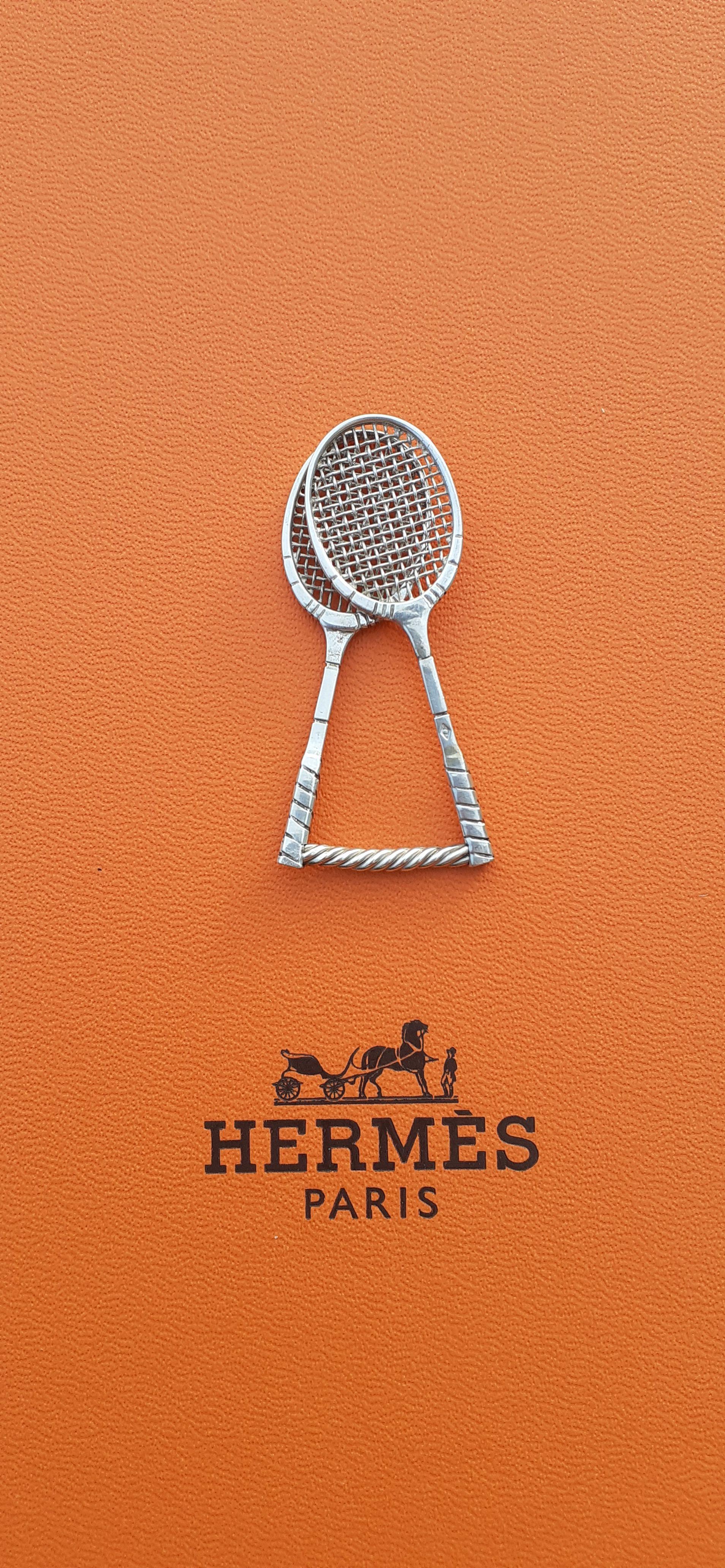 Rare and Lovely Authentic Hermès Tie Clip

Shaped like 2 tennis rackets

Made for IPTA (Internationa Platform Tennis Association)

Probably a vintage item considering the box

Made of Silver (crab hallmark)

