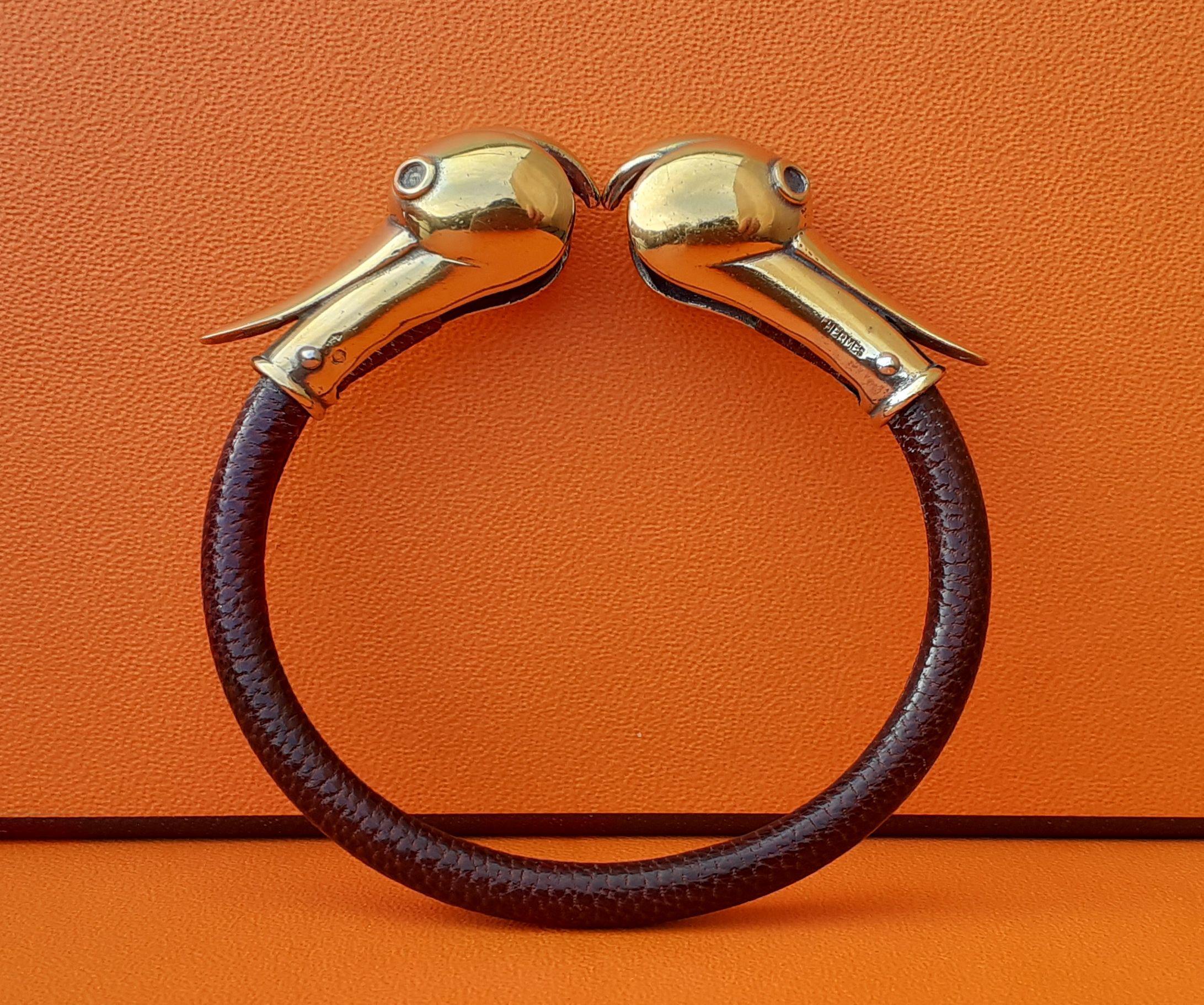 Extremely Rare Authentic Hermès Bracelet

In shape of Ducks Heads

Open bracelet

Vintage Item

Made of Lizard Skin and Vermeil (silver covered with gold)

Colorways: Brown, Golden

