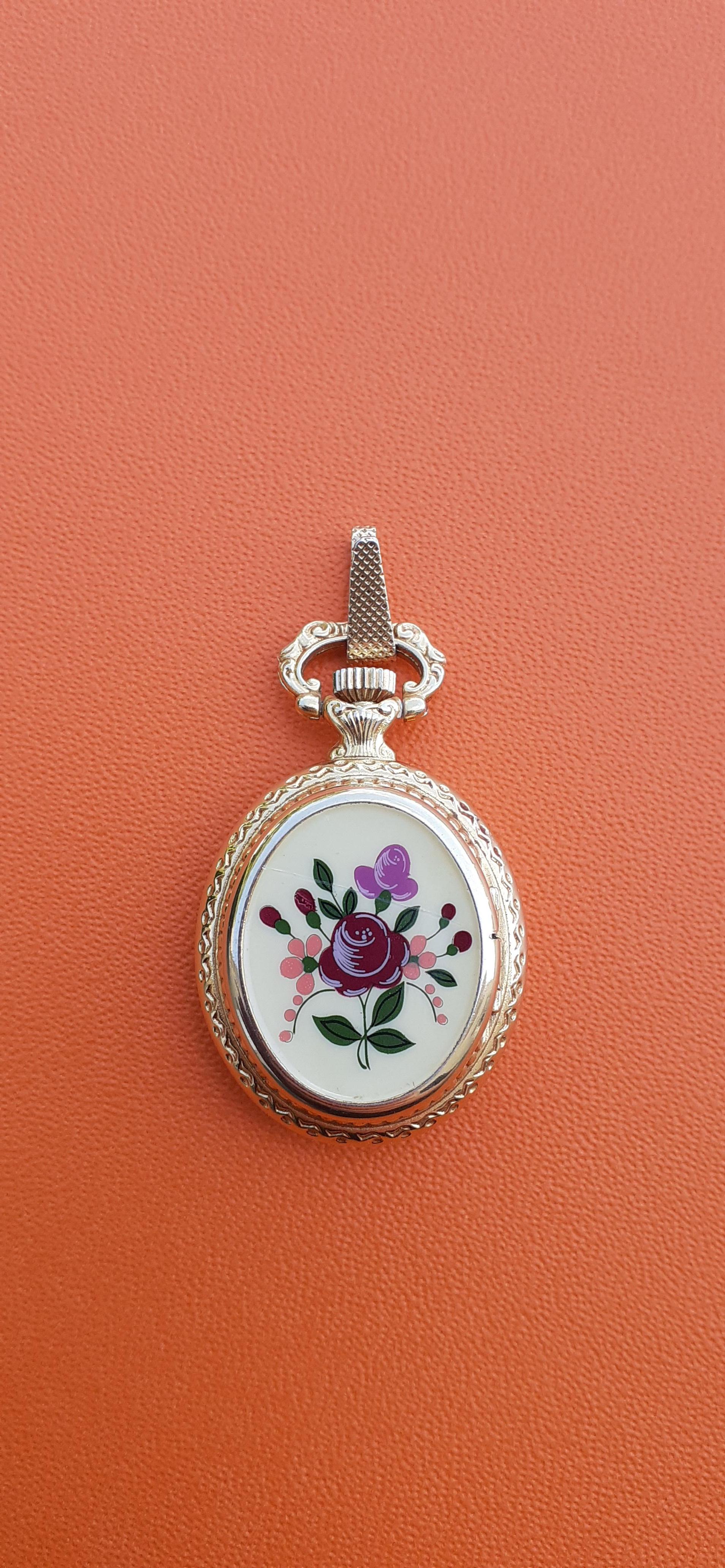 Extremely Rare Authentic Hermes Watch

Exceptional Watch hidden in a golden metal pendant, the lid decorated with enamel printed with flowers.

To wear as a pendant (the dial has been fixed upside down for this purpose)

Please notice: the chain on