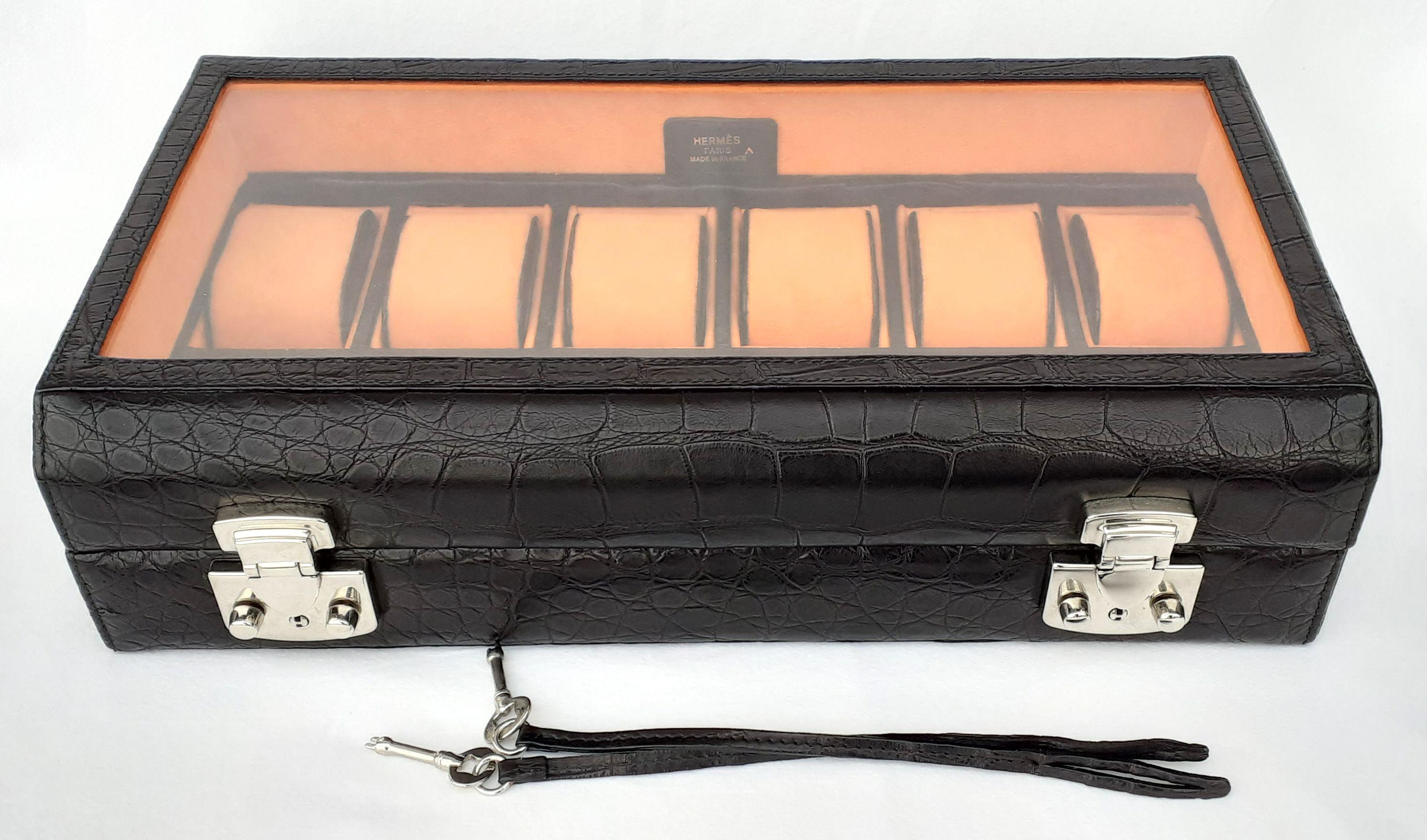 Rare and Gorgeous Authentic Hermès Watch Box

To store watches, but can be used to store jewels as well

Made of Crocodile Porosus

Inside includes 12 boxes and 12 orange felt cushions covered with crocodile

Lid is made of glass

Tag made of