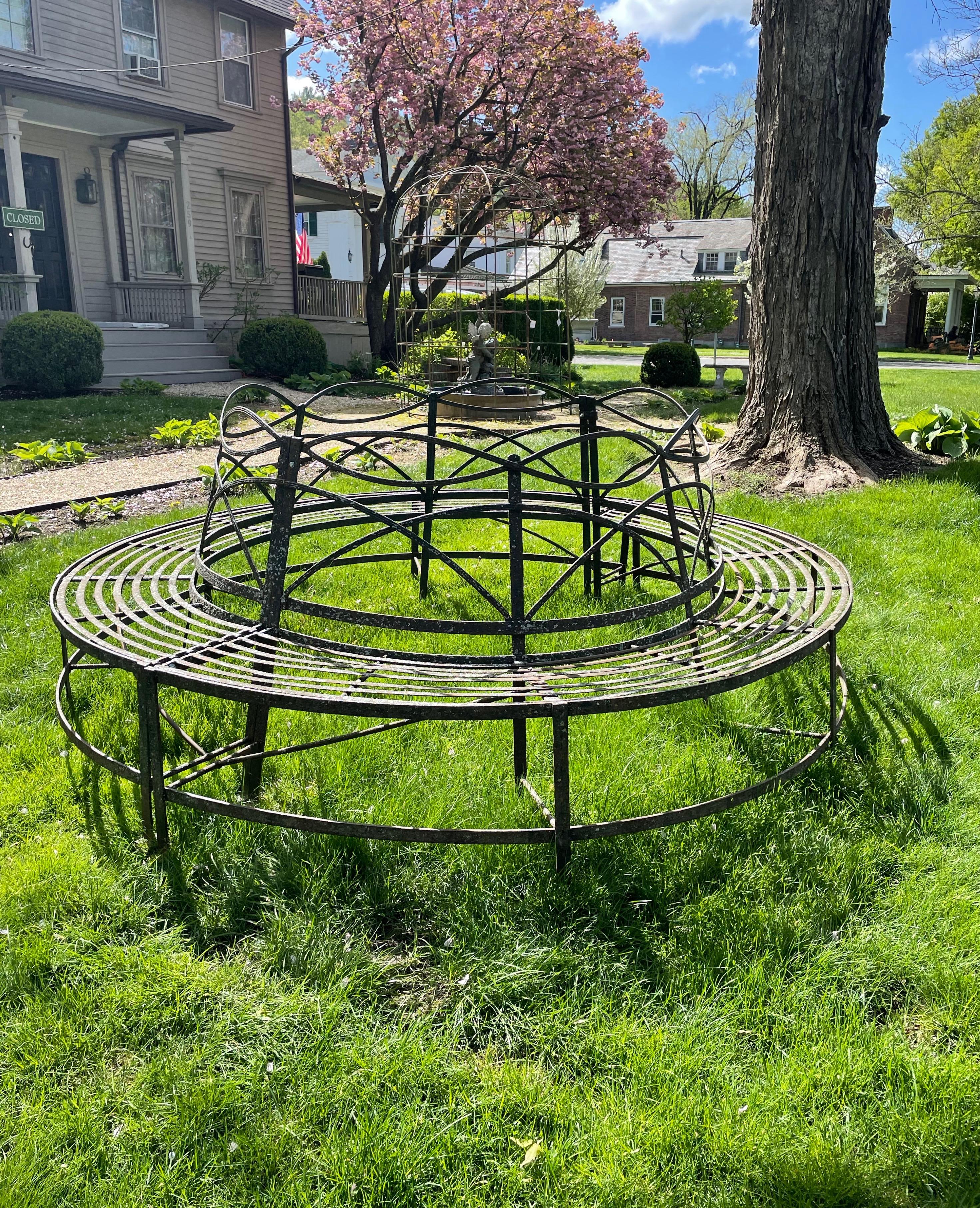 We have never seen a Regency tree bench as large and impressive as this one, in spite of the professional restorations that we estimate are about 20 years old. In two parts that easily bolt together, it has a fabulous faded black patina with lots of