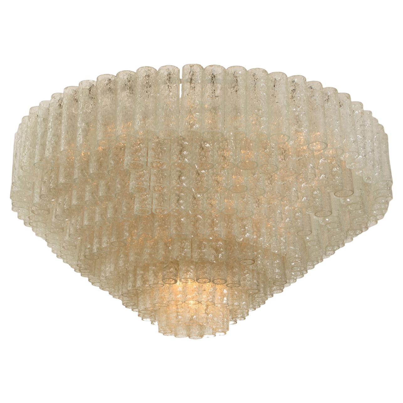 Exceptional, clean and modern nine-light ballroom chandelier by Doria Leuchten from the 1960s. The fixcture consists layers with several hand blown textured glass tubes (and five reserve) mounted on a brass frame arranged in concentric rings. This