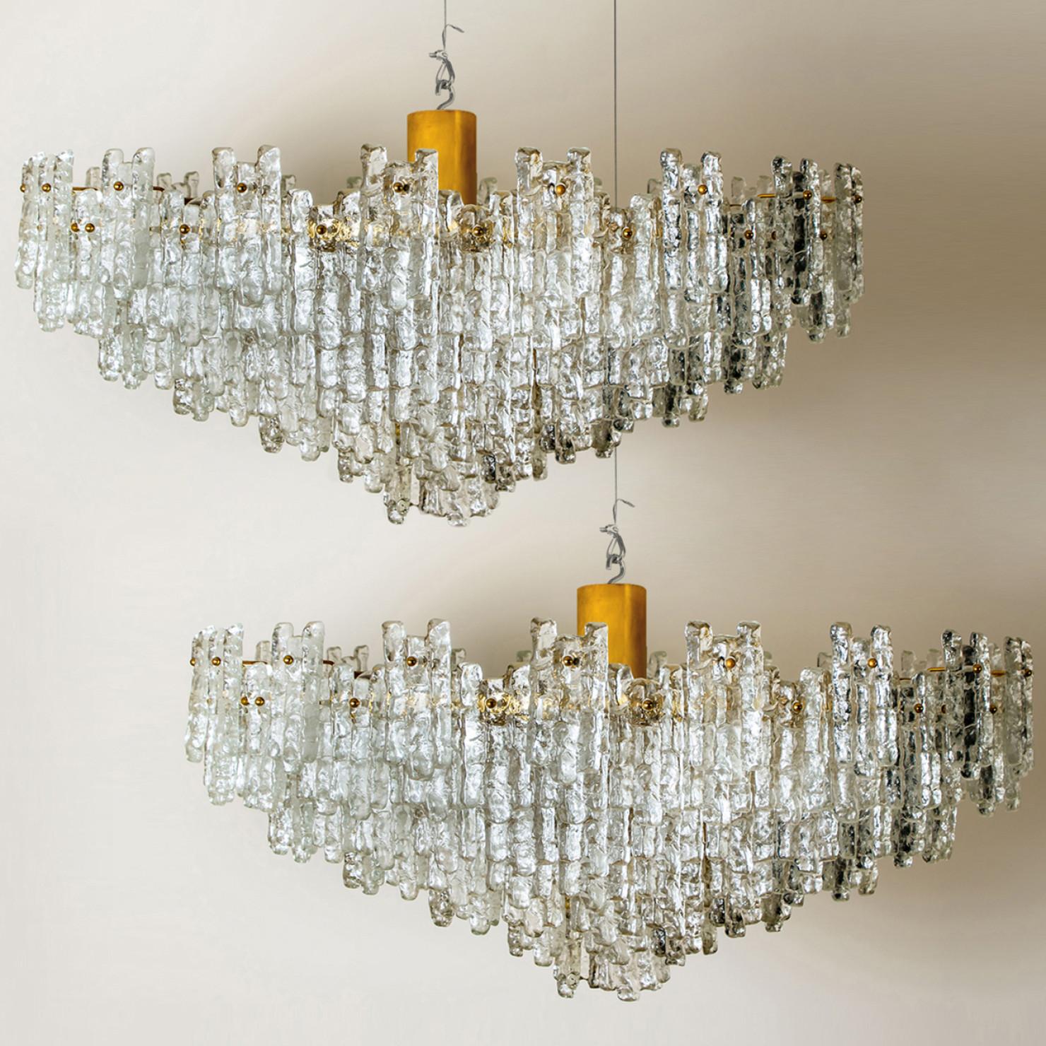 1 of the 2 exceptional, huge, clean and modern six-tier ballroom flush mount chandelier by J.T. Kalmar Leuchten from the 1960s. The chandelier consists six layers with a 141 hand blown textured glass shades mounted on a brass frame arranged in