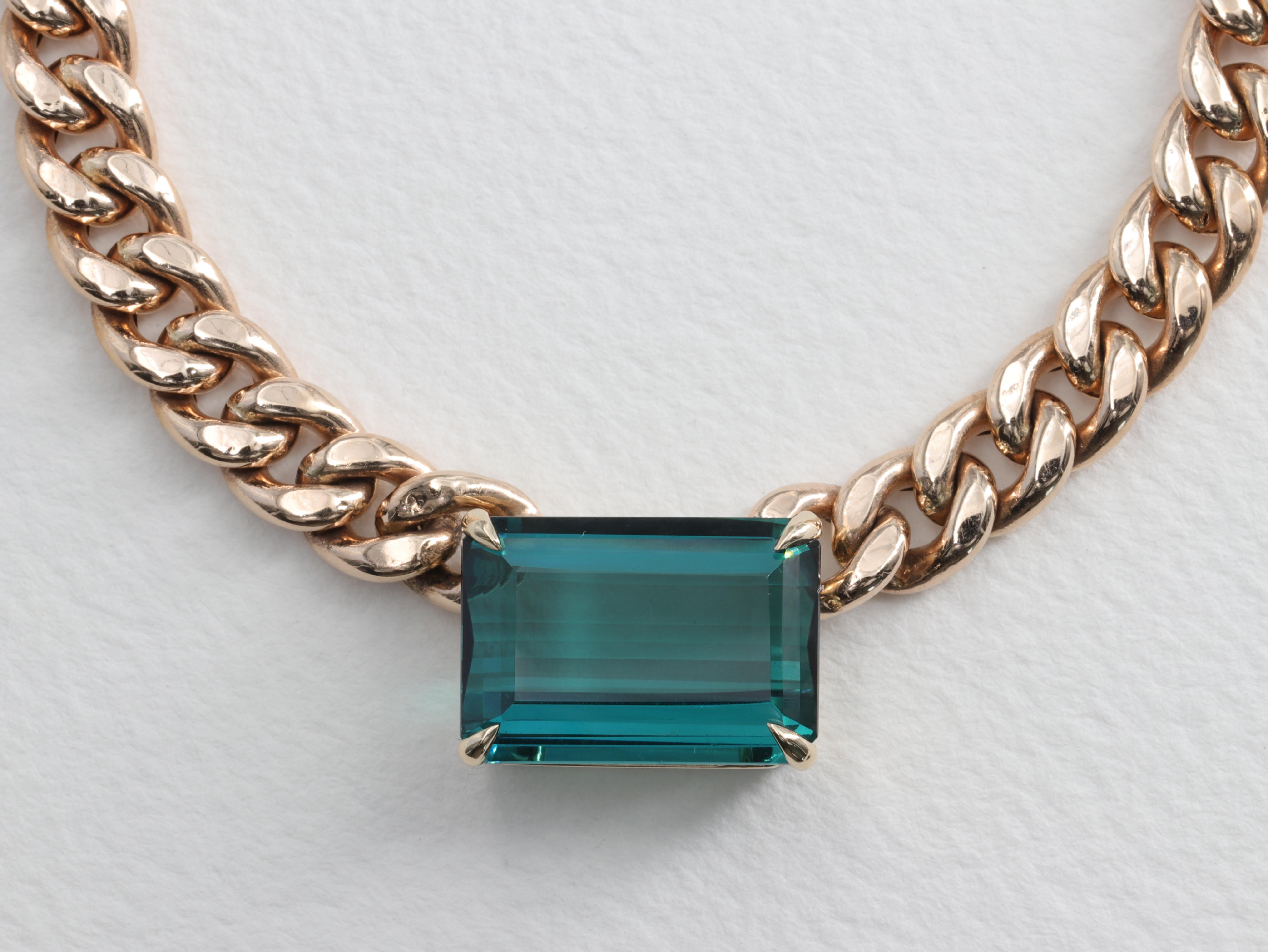 Exceptional Indicolite Tourmaline Necklace Vintage Curb Link 14 Karat Yellow Gold Chain

Tourmaline:

Color- Blue Green 
Measurement - 17 x 12 x 6.8
Weight - 12.5 Carats

Chain:

Semi Solid
Length - 15in 
Weight - 26.6 G
Hallmarks - 14K / Italy / AFR