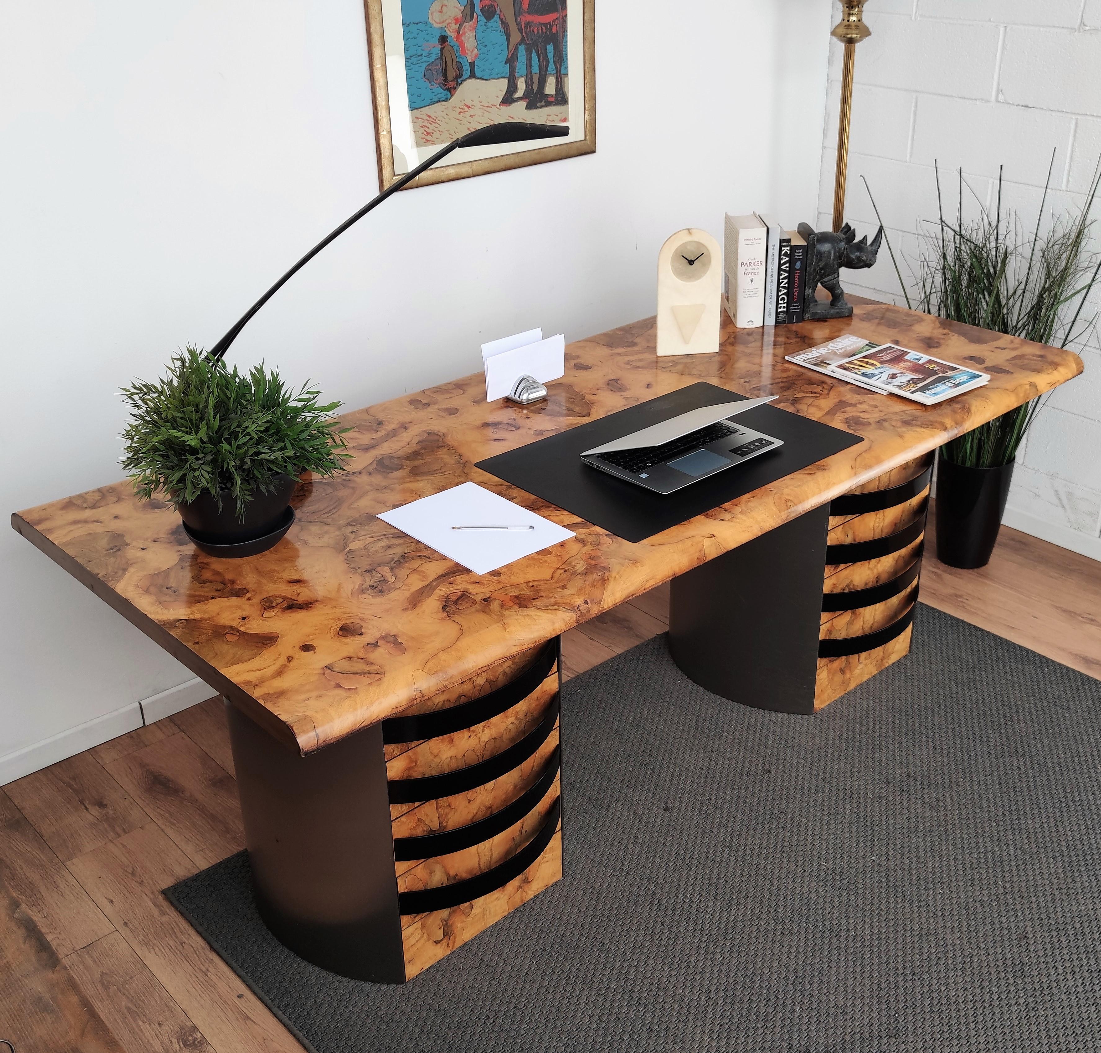 An exceptional, impressive and rarely seen Italian executive desk with its stunning veneer burl wood pattern. The huge (82.6 x 37.4 inch) and beautiful top of the desk is standing on 2 circular steel stands, offering a total of eight drawers, four