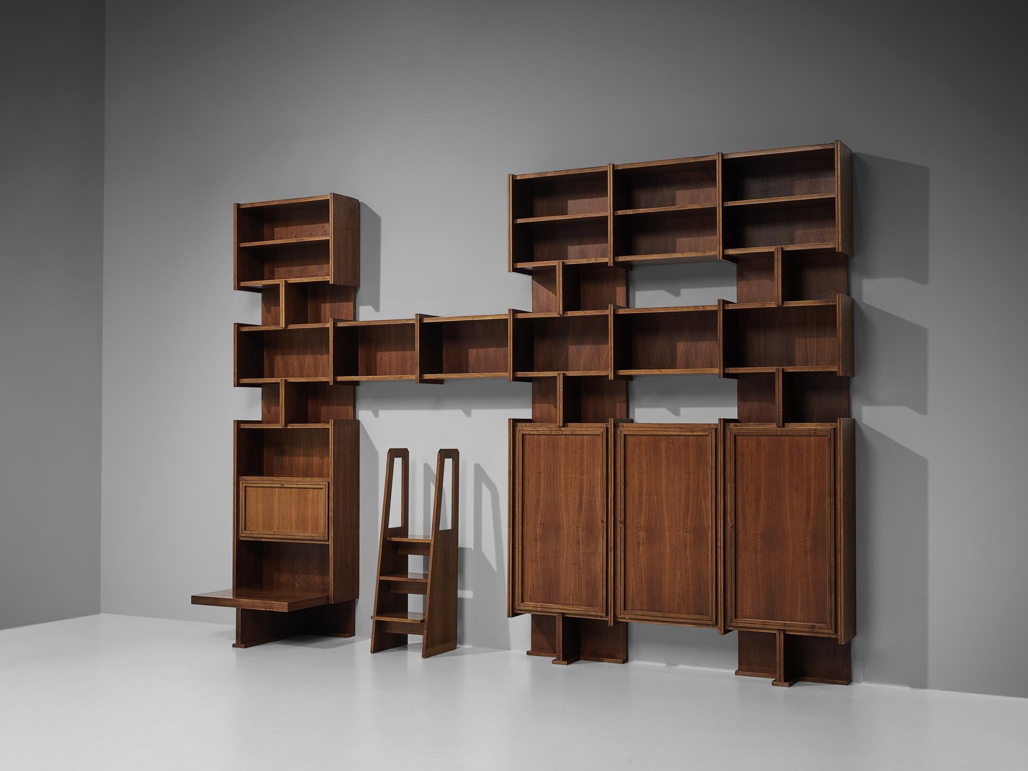 Library unit with stairs, walnut, Italy, 1950s.

Extraordinary Italian library unit including a stairs, all executed in the finest walnut wood. The look of this wall unit is very versatile in the way that multiple features are composed together as a