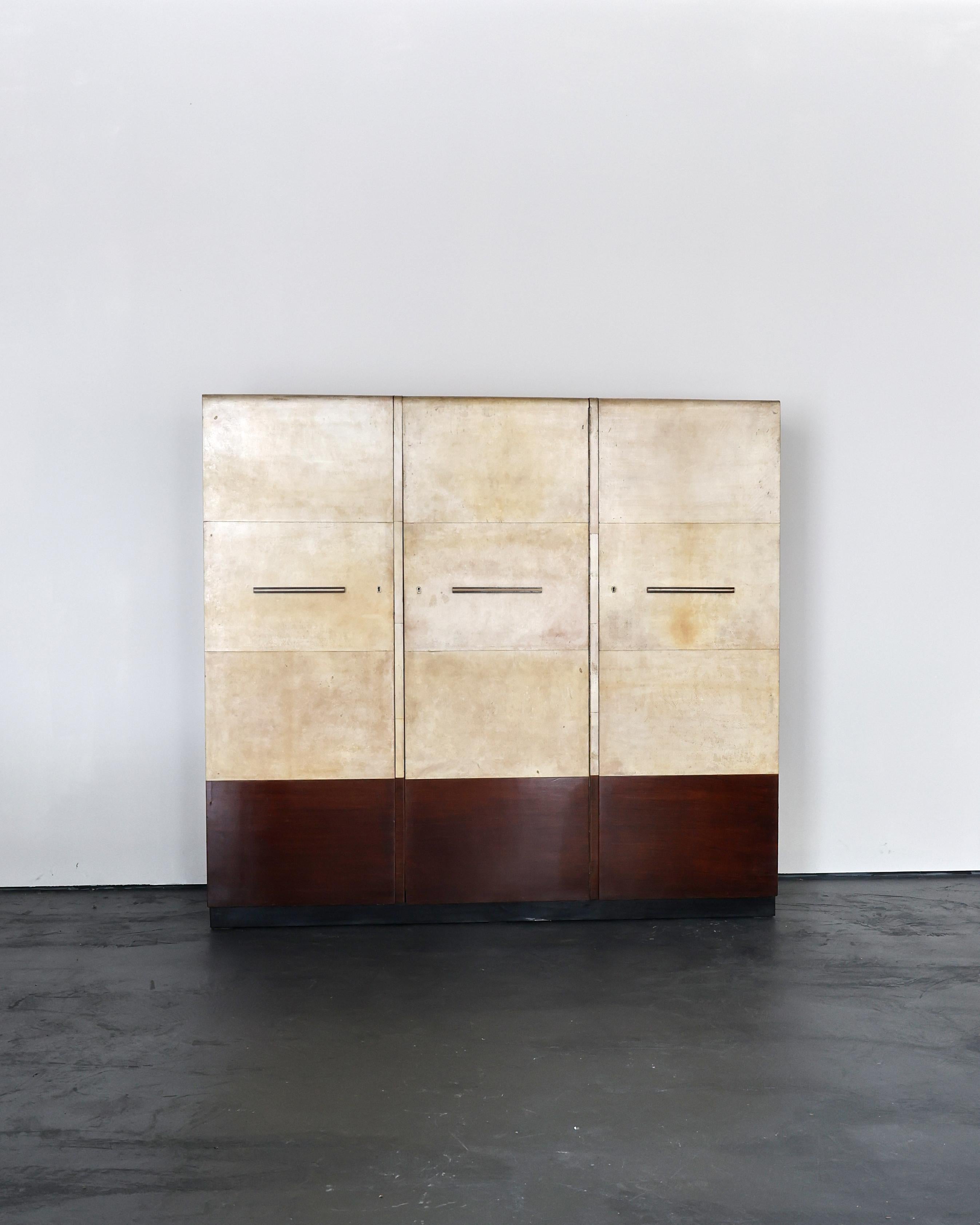 An exceptional C.1940s northern Italian parchment/vellum wardrobe.

Ample storage behind the three doors featuring, four shelves, two rails & two drawers.

Nicely patinated with age related wear throughout.

Recently sympathetically restored in our