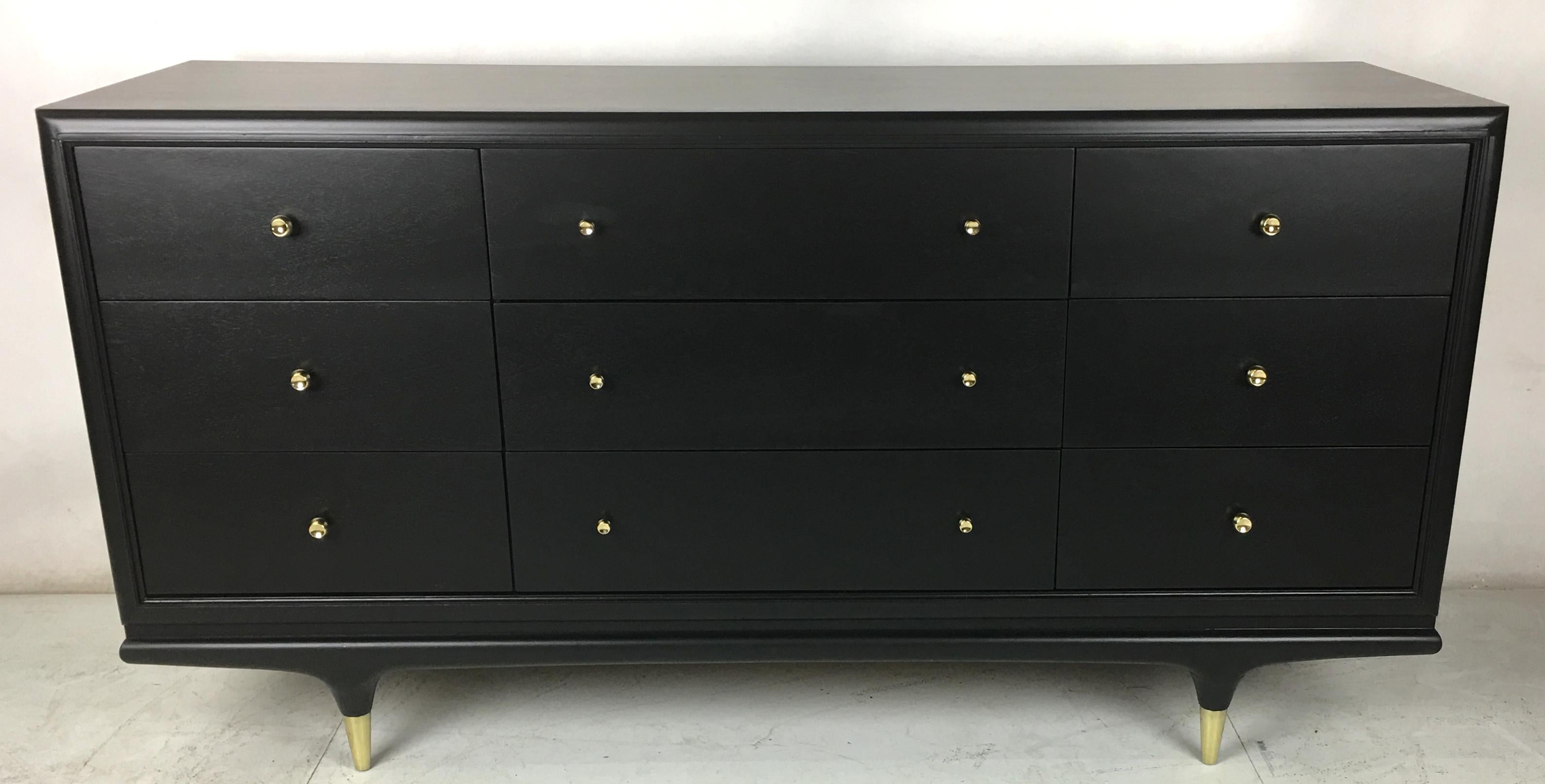 Beautiful Italian style walnut dresser with brass hardware refinished in natural open grain black lacquer. The stiletto legs have tall polished brass sabots and all of the brass elements have been professionally polished and lacquered. Meticulously