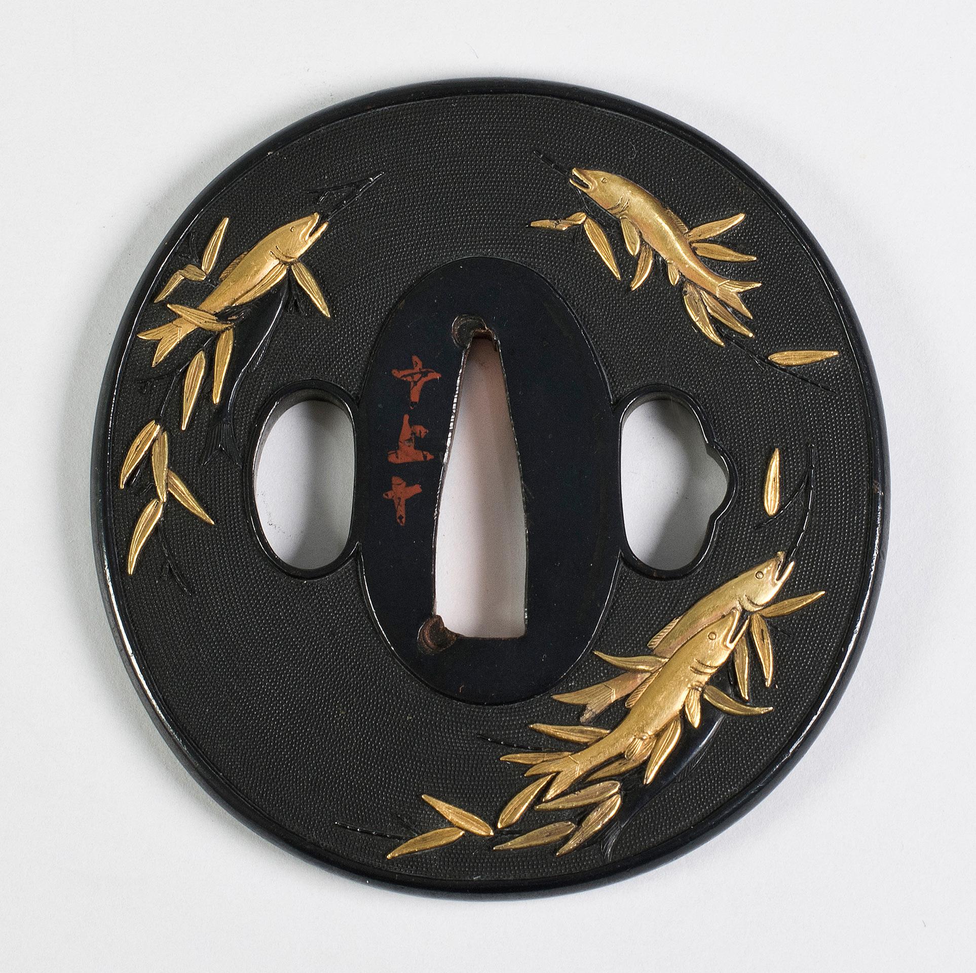 As part of our Japanese works of art collection we are delighted to offer this exceptional quality Edo/ Meiji period shakudo tsuba of oval from, this striking example finely detailed in nanako ground depicts a school of fish upon bamboo, a most