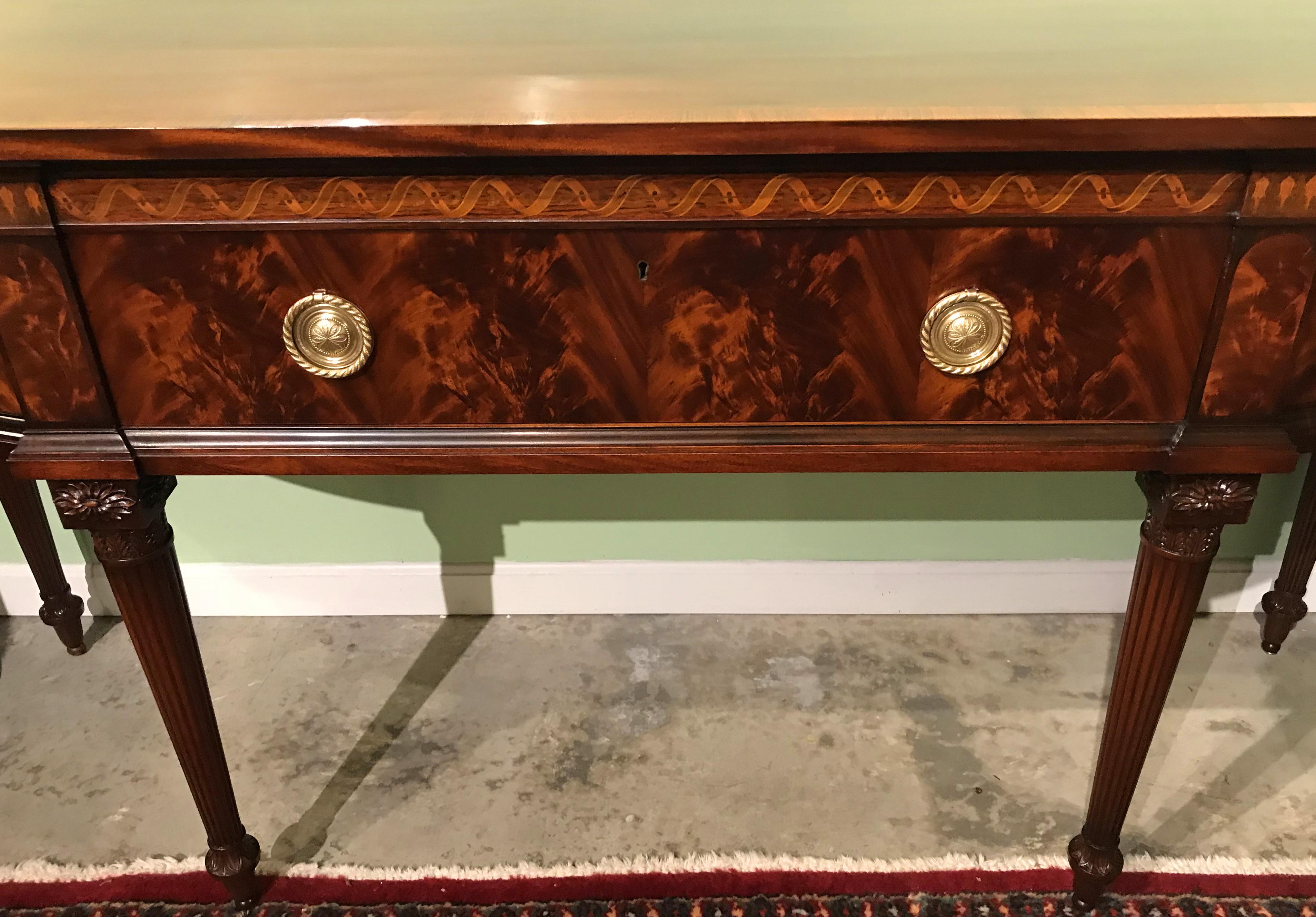 An exceptional Georgian style custom mahogany demilune server or sideboard by Joseph Gerte of Boston MA, with conforming top with rosewood surmounting a center lined frieze drawer with sliding sections that can accommodate two layers of flatware,