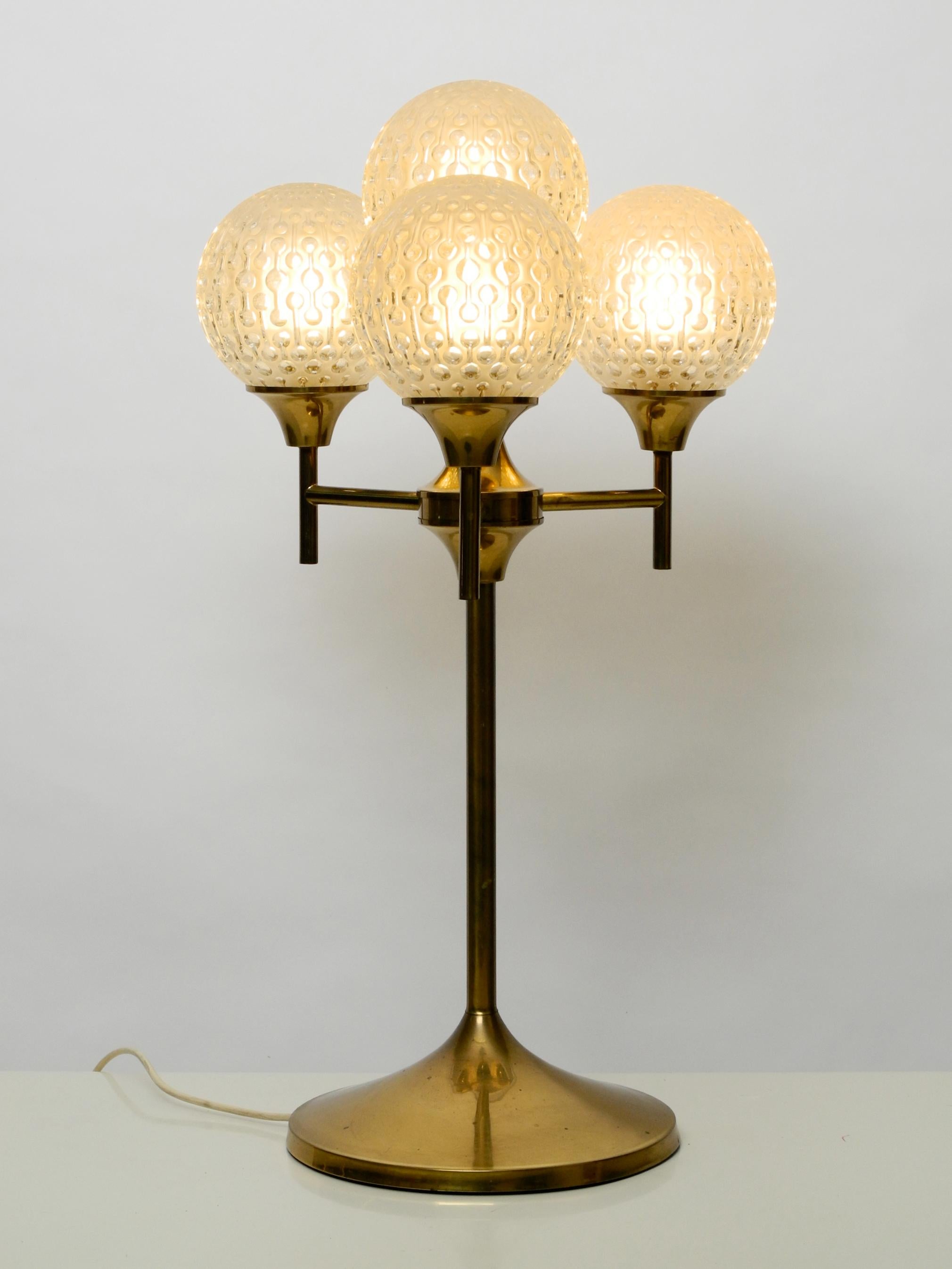Exceptional large 1960s full brass table or floor lamp.
Massive lampshades made of 4 heavy glass spheres with abstract circle pattern.
Great minimalistic design with many details and very high quality.
100% original condition and fully
