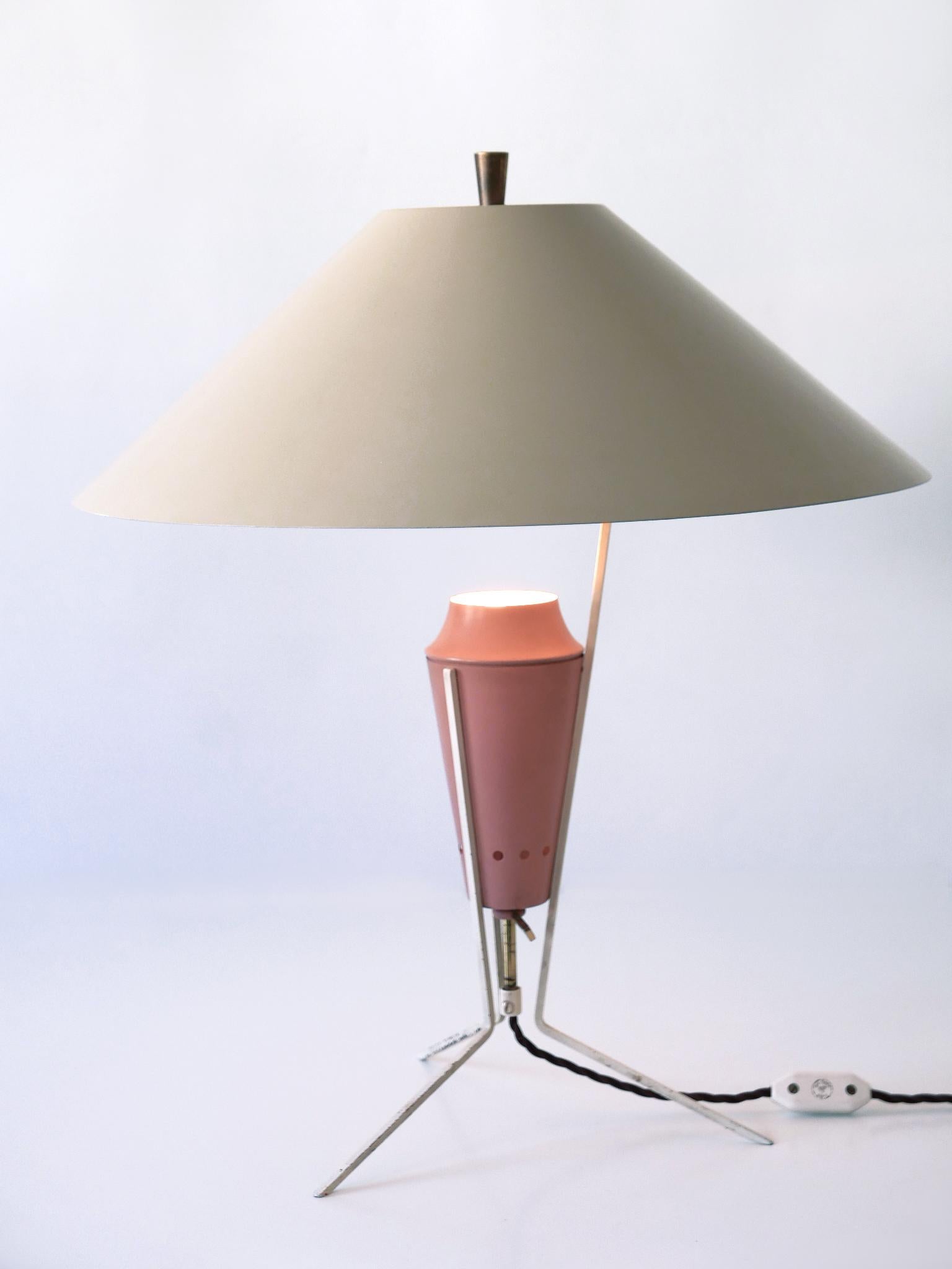 Extremely rare, large and highly decorative Mid-Century Modern table lamp. Designed and manufactured in Germany, 1950s.

This sculptural table lamp is executed in pastel colors enameled metal, aluminium and brass. It comes with an E27 / E26 Edison