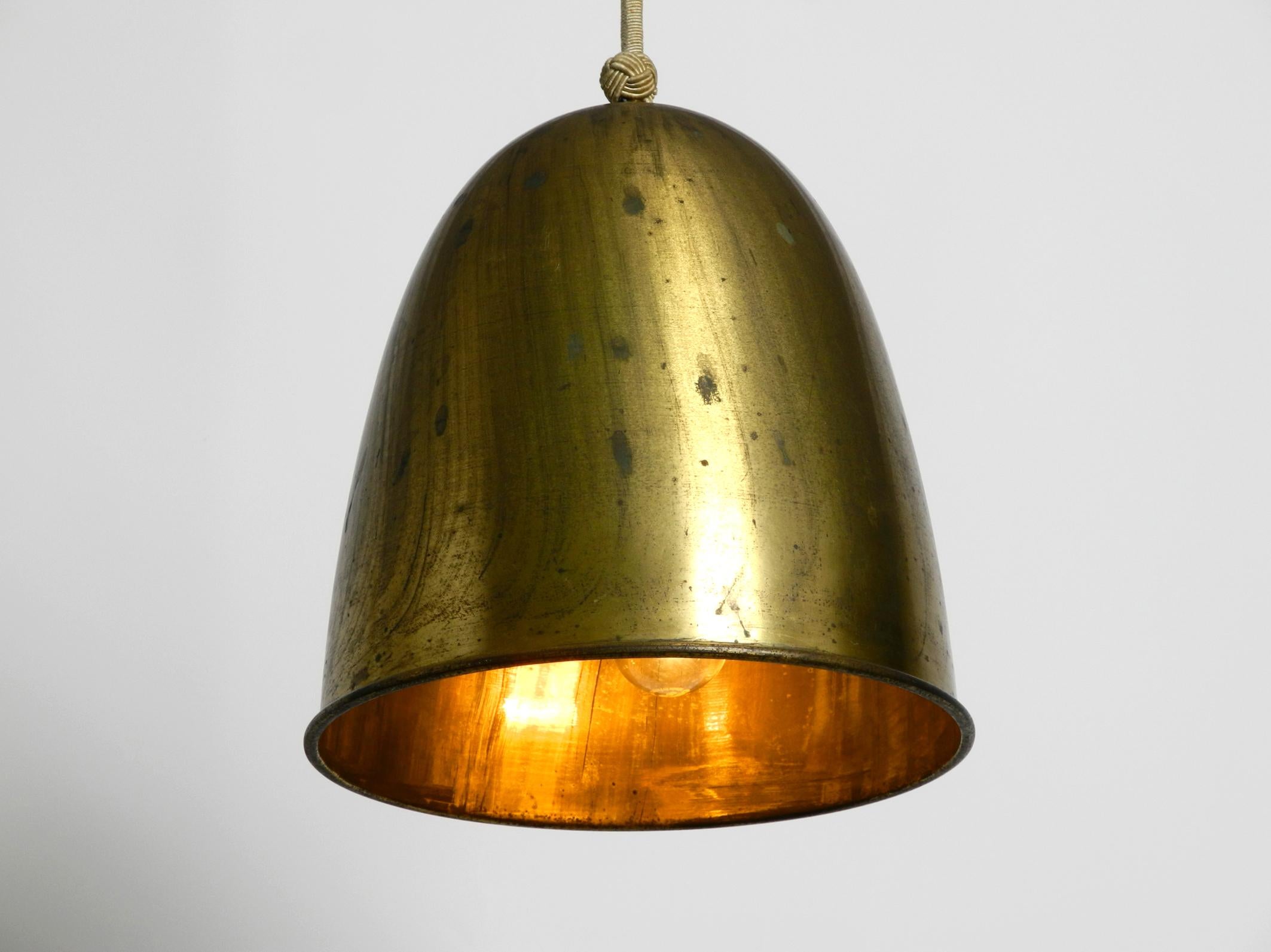 Very rare and large heavy midcentury brass pendant lamp with brass shade. Three original E27 sockets inside the lampshade.
Exceptional design in original condition.
Lampshade is made of solid, heavy brass with a very nice patina.
This lamp hung