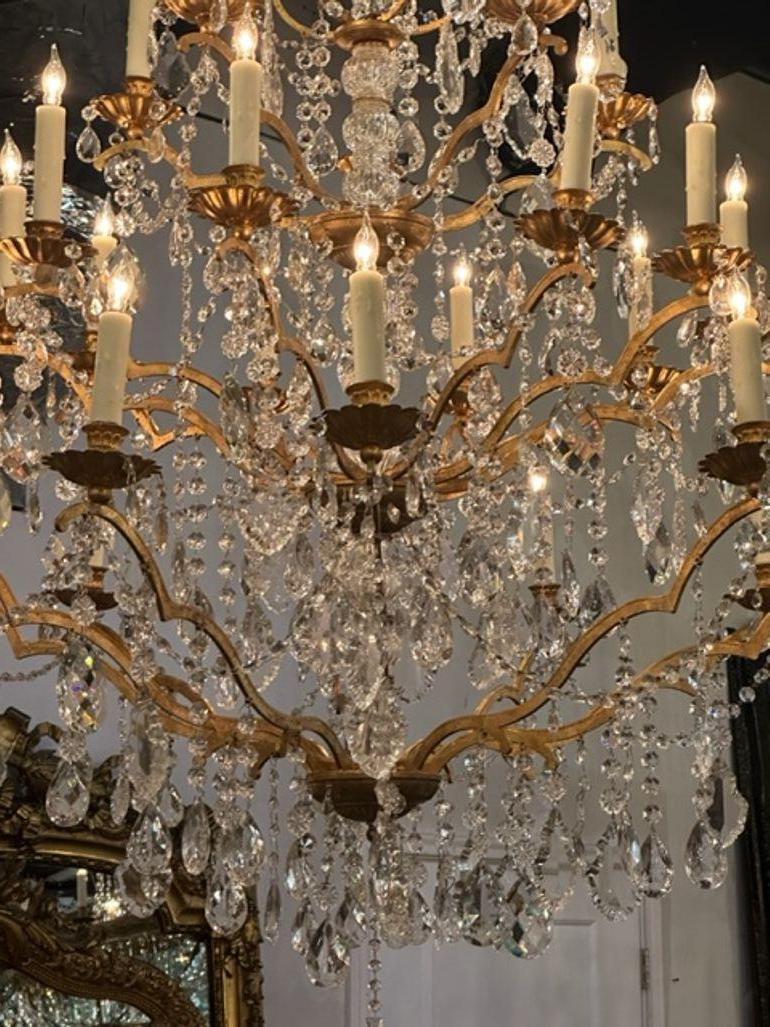 Outstanding large Italian crystal chandelier with 25 lights. Featuring gorgeous crystals, a lovely base with 3 tiers of lights. A fabulous piece that is so elegant!