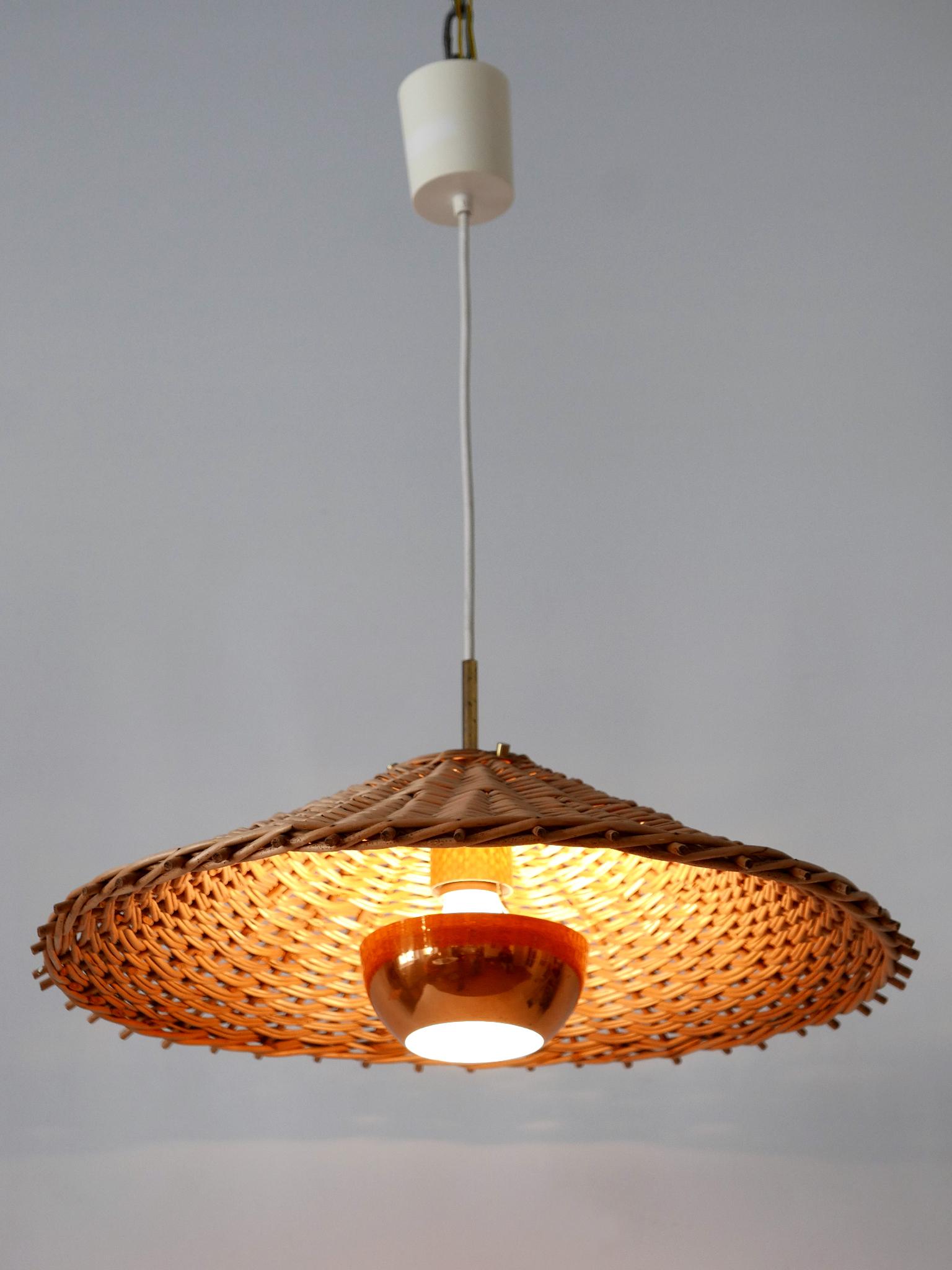 Extremely rare, lovely and highly decorative Mid-Century Modern pendant lamp. Designed and manufactured probably in Scandinavia, 1960s.

Executed in rattan, brass and copper, the pendant lamp comes with 1 x E27 / E26 Edison screw fit bulb holder, is